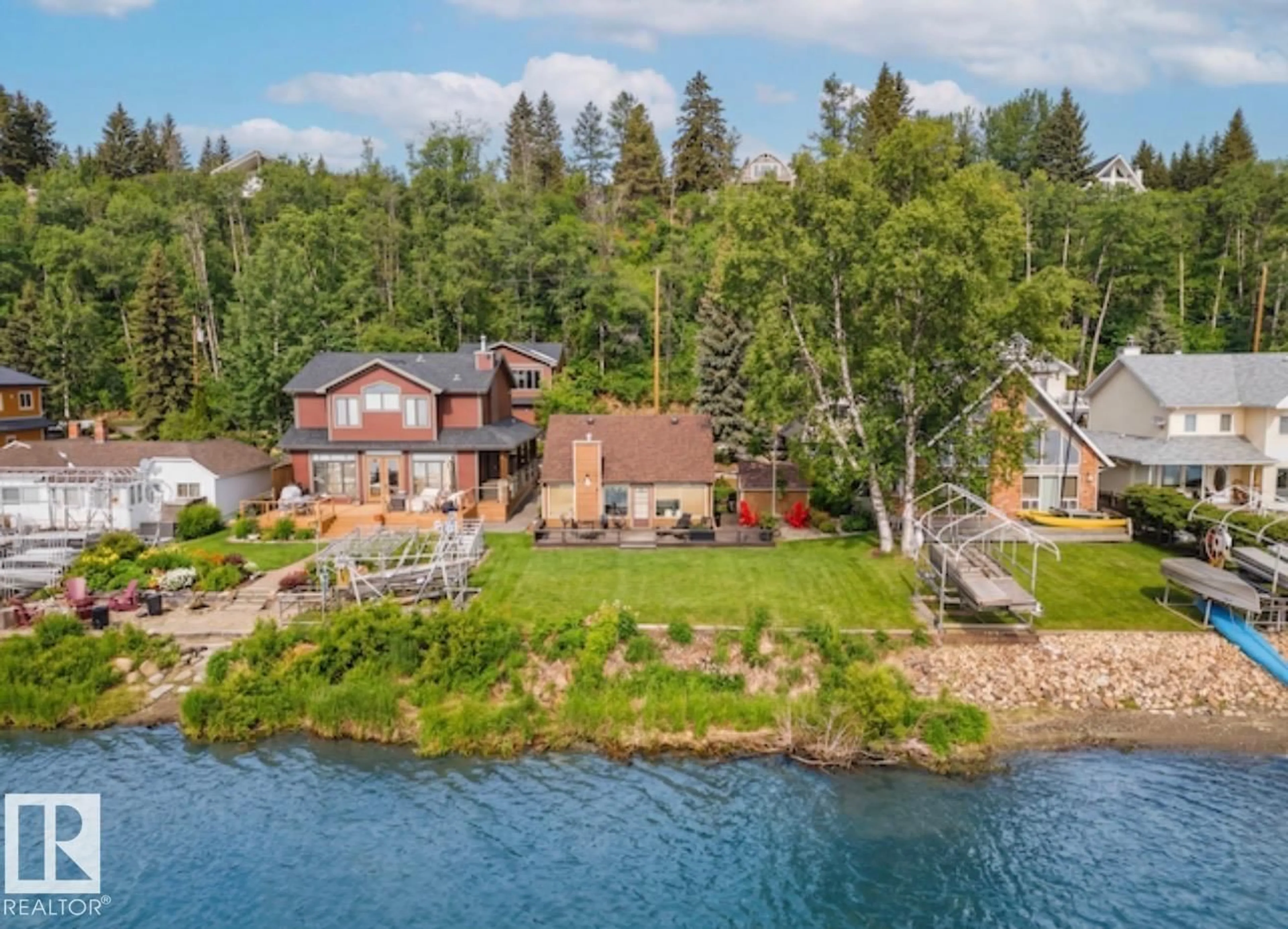 A pic from outside/outdoor area/front of a property/back of a property/a pic from drone, water/lake/river/ocean view for 595 1 AV N, Rural Parkland County Alberta T0E2B0