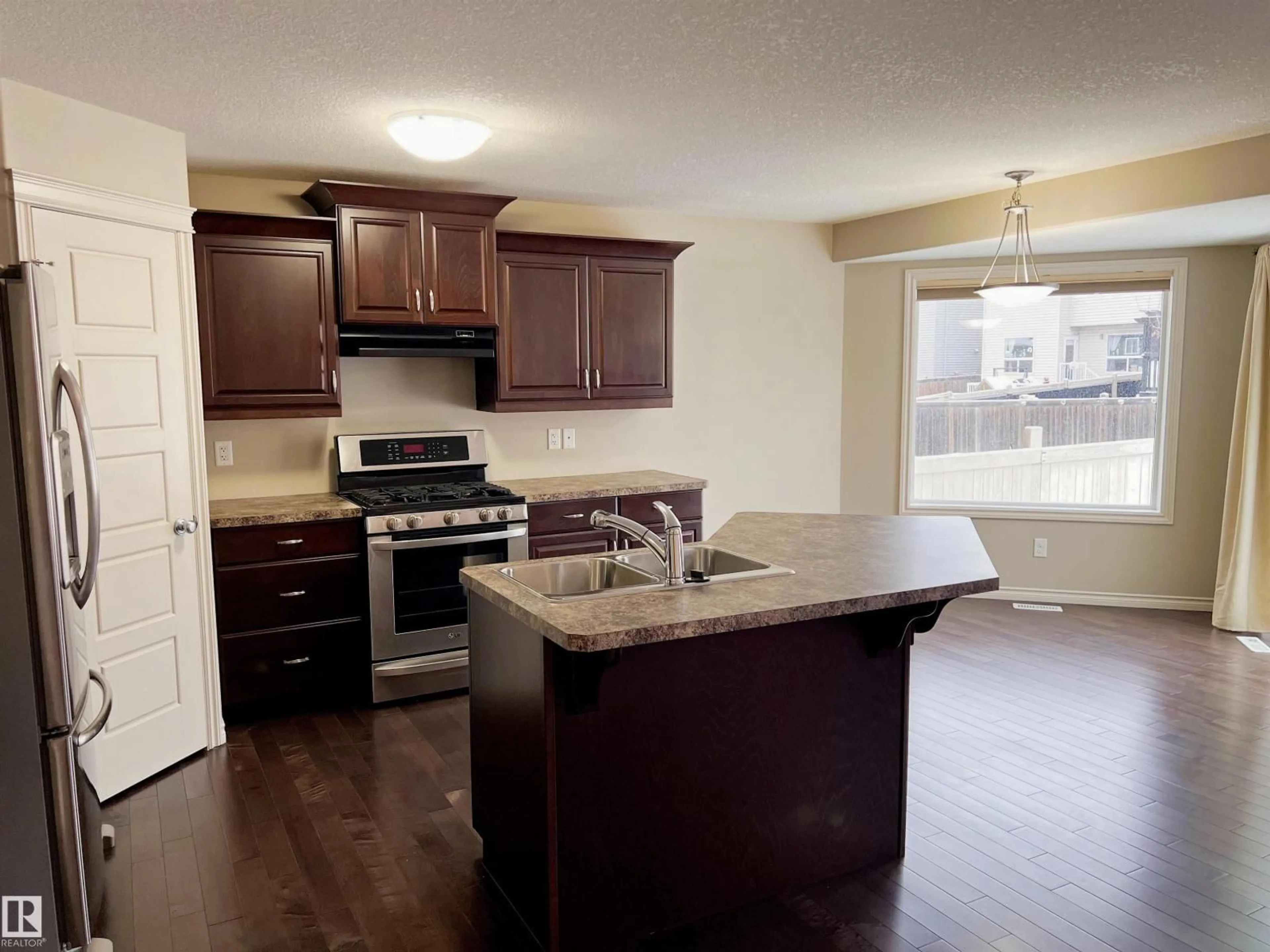 Open concept kitchen, wood/laminate floor for 1117 59A ST, Edmonton Alberta T6X0T2