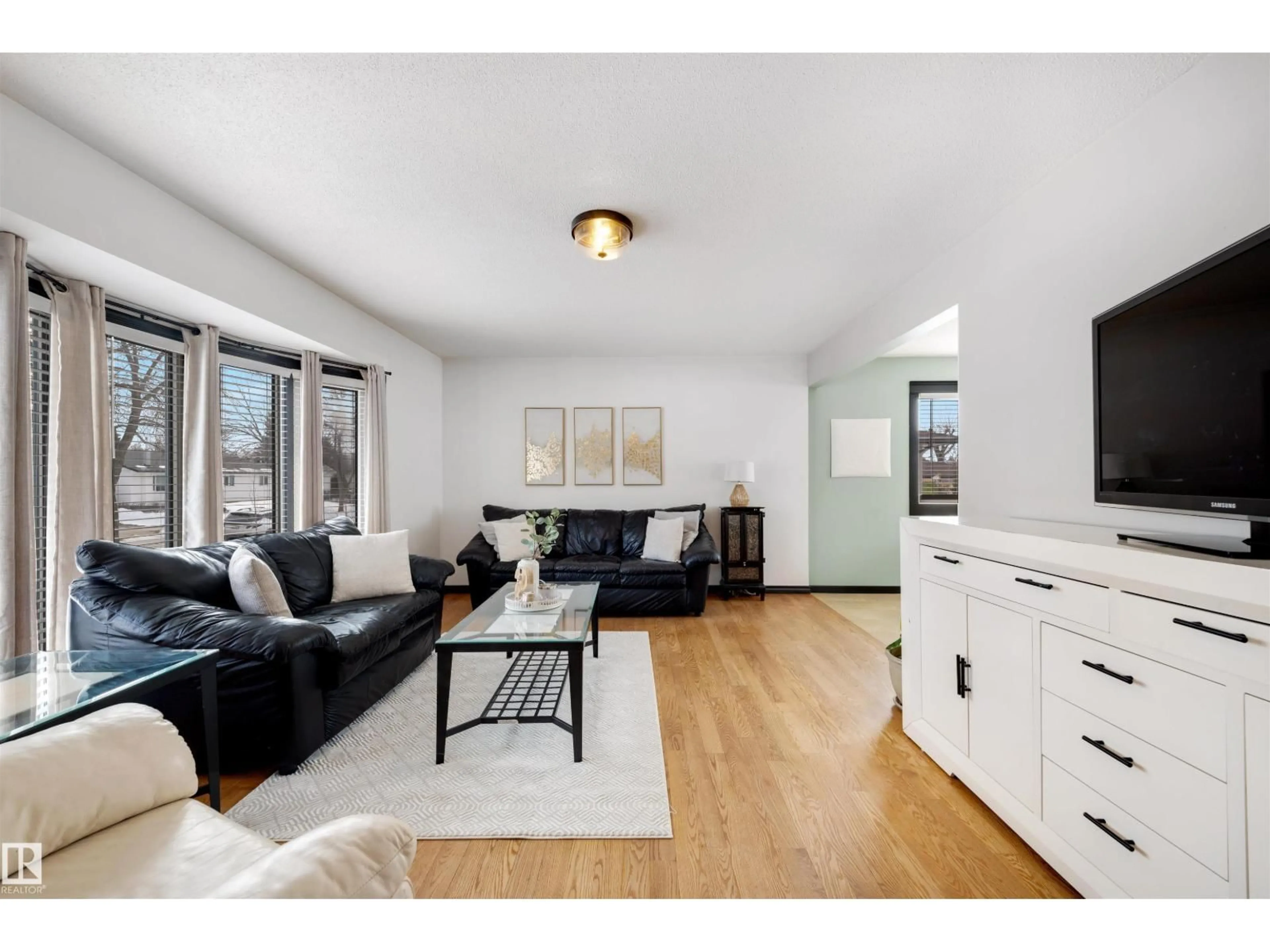 Living room with furniture, wood/laminate floor for 9028 95 AV, Fort Saskatchewan Alberta T8L1C6