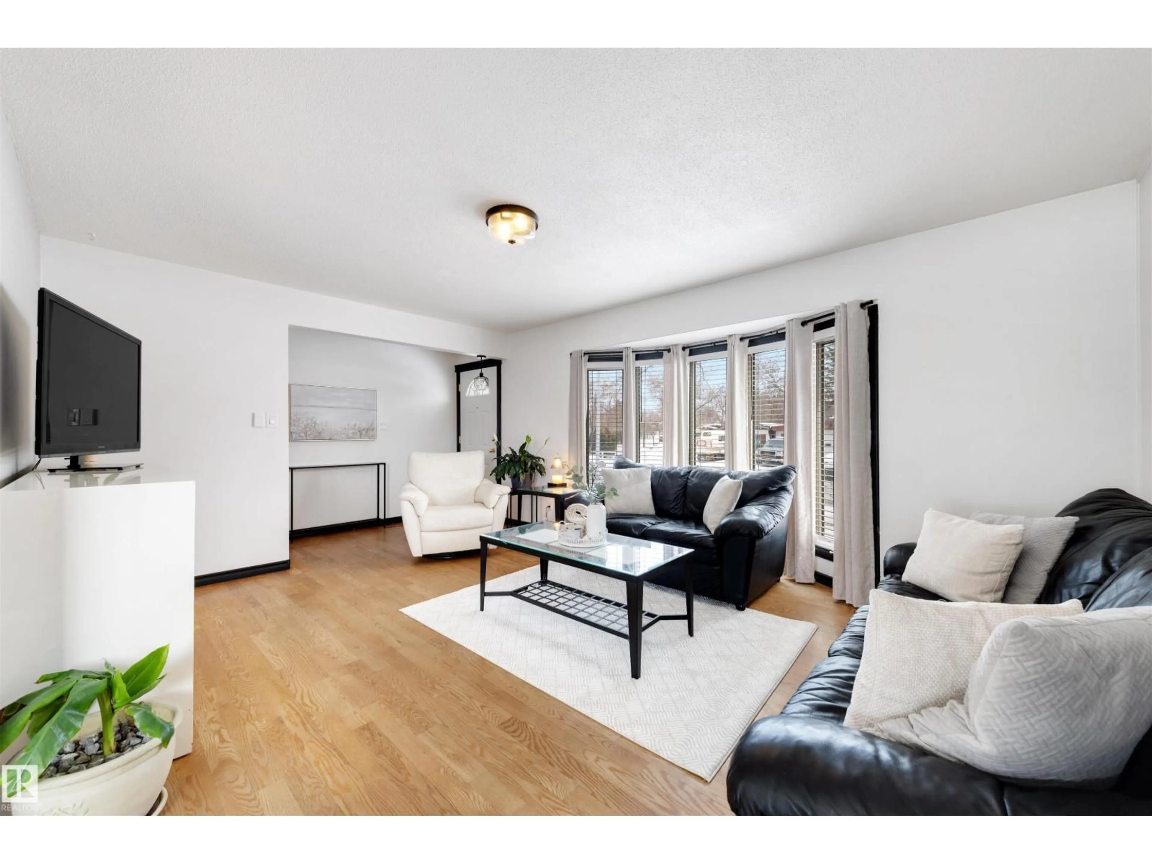 Living room with furniture, wood/laminate floor for 9028 95 AV, Fort Saskatchewan Alberta T8L1C6