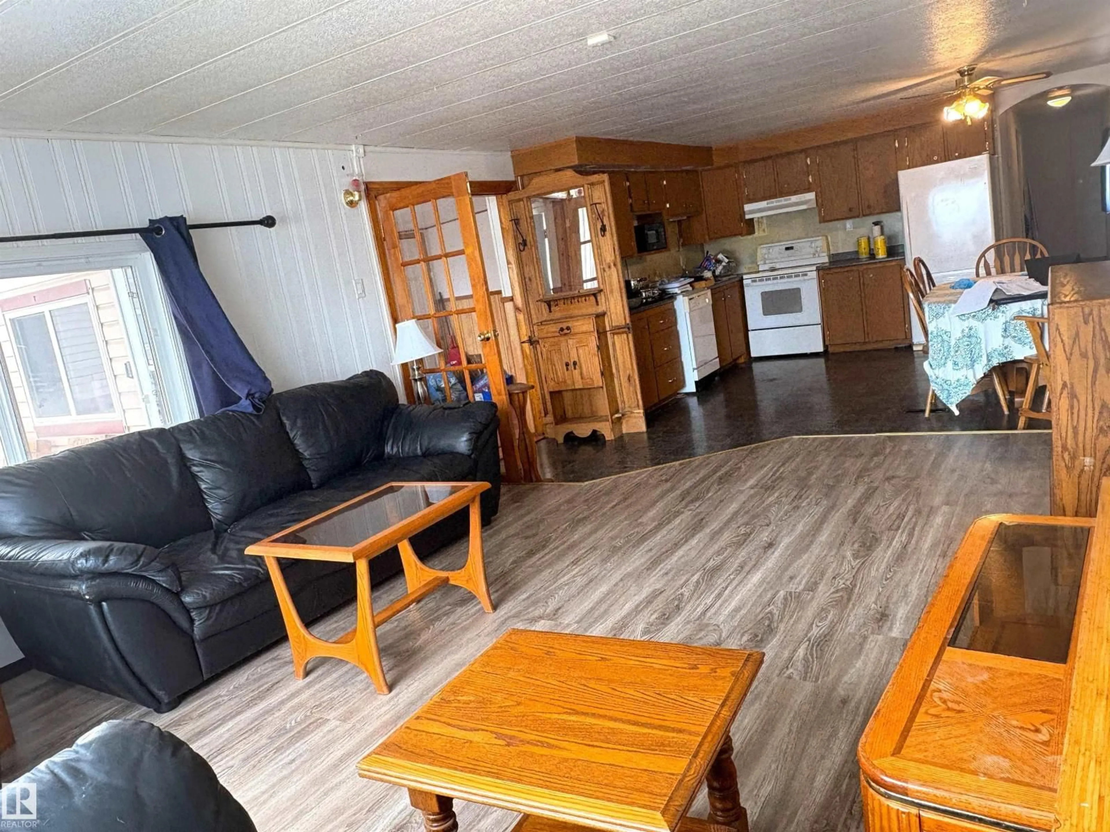 Living room with furniture, wood/laminate floor for 10410 101A STREET, Morinville Alberta T8R1B1