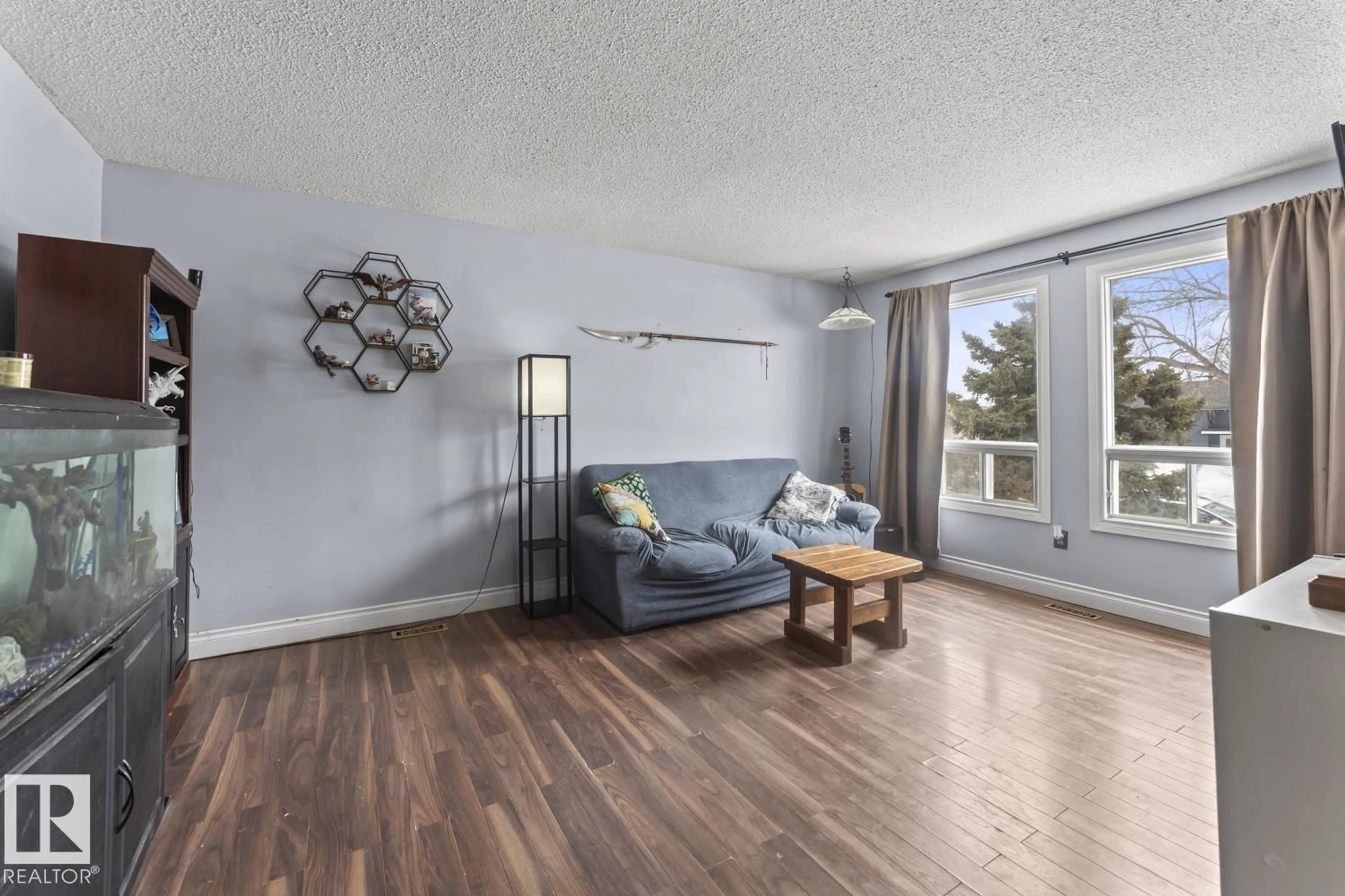 Living room with furniture, wood/laminate floor for 1815 FOREST DR, Cold Lake Alberta T9M1L9