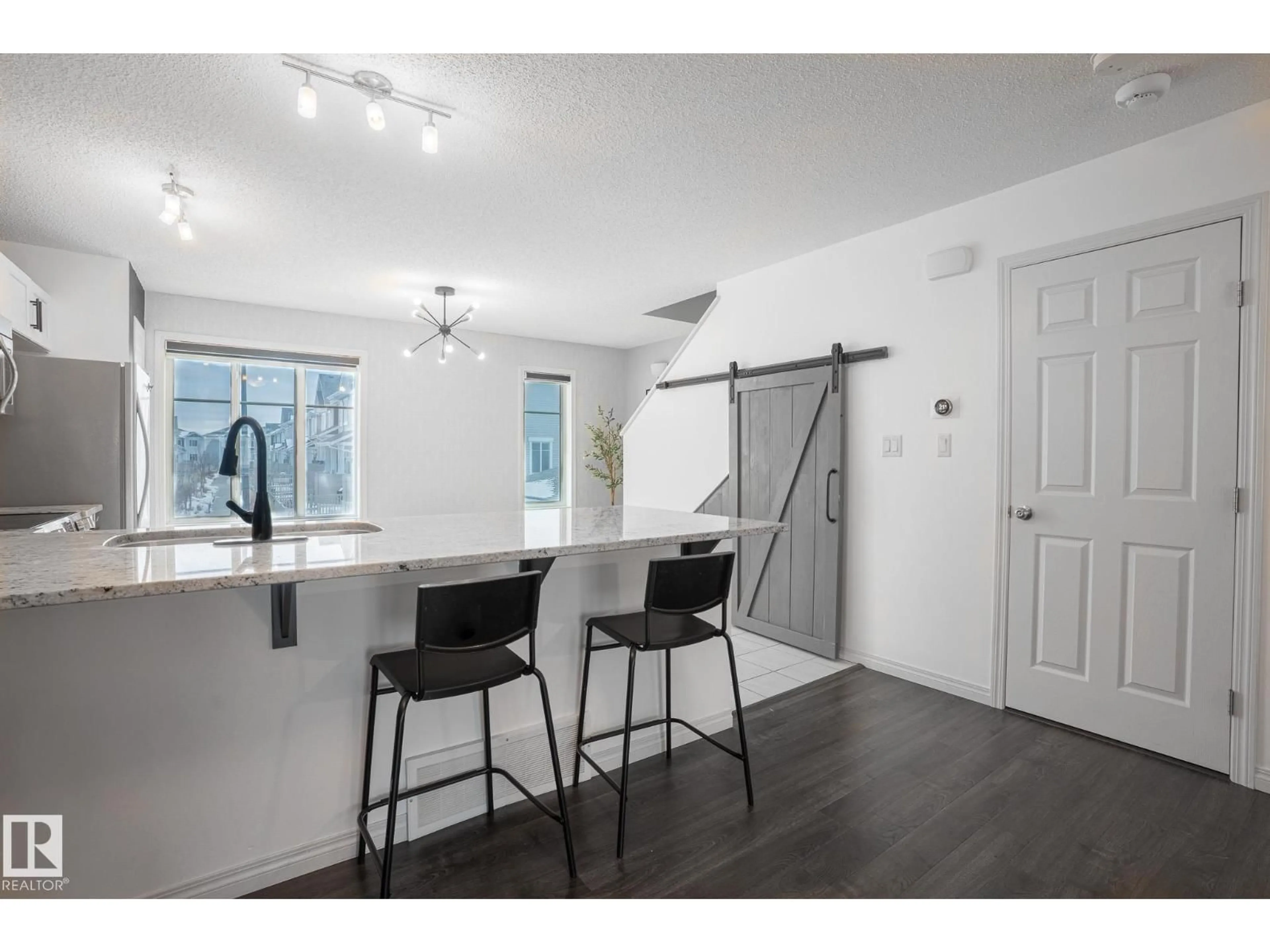 Open concept kitchen, wood/laminate floor for #13 - 2905 141 ST, Edmonton Alberta T6W1S4