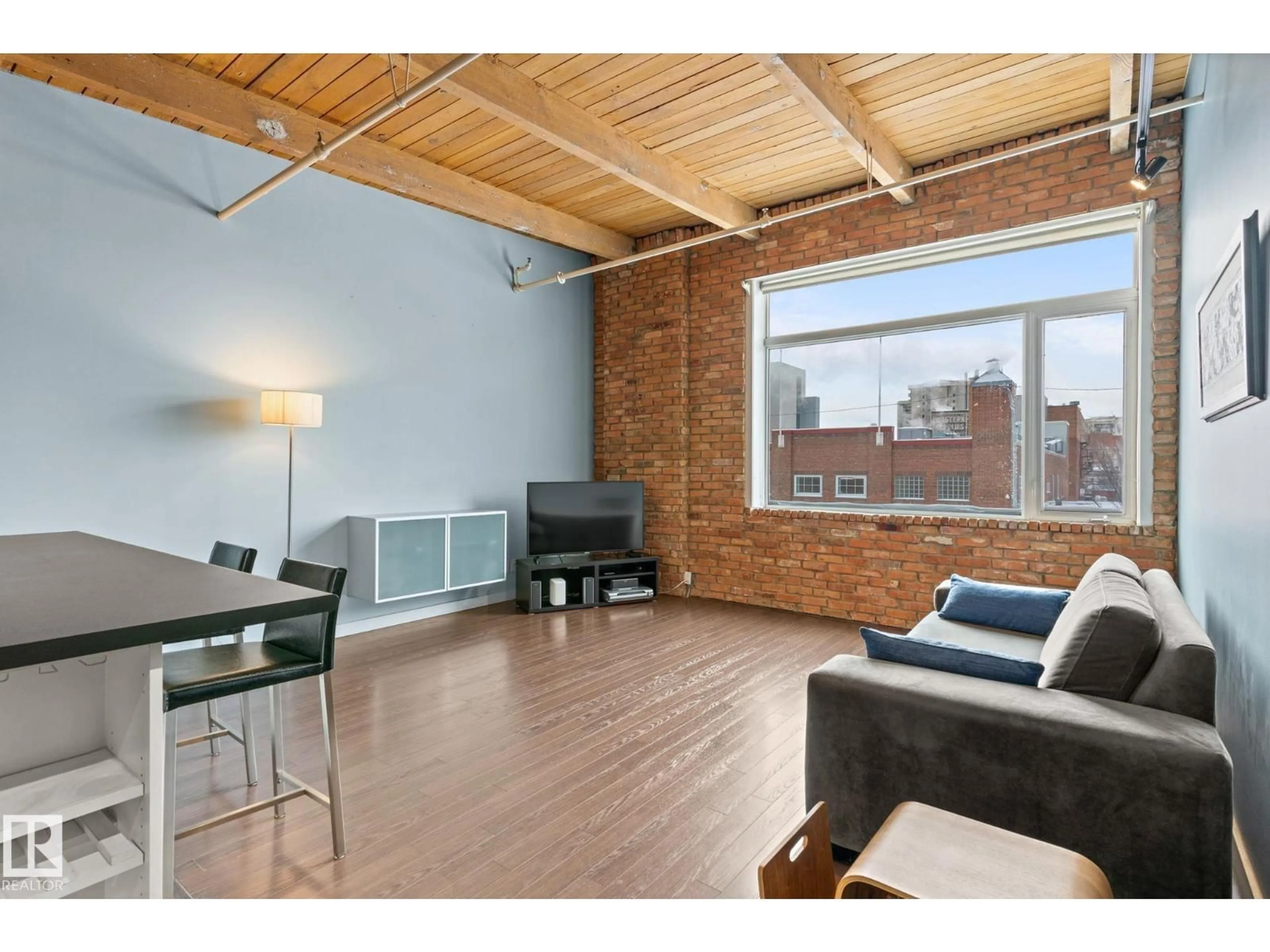 Living room with furniture, wood/laminate floor for 213 - 10309 107 ST, Edmonton Alberta T5J1K3
