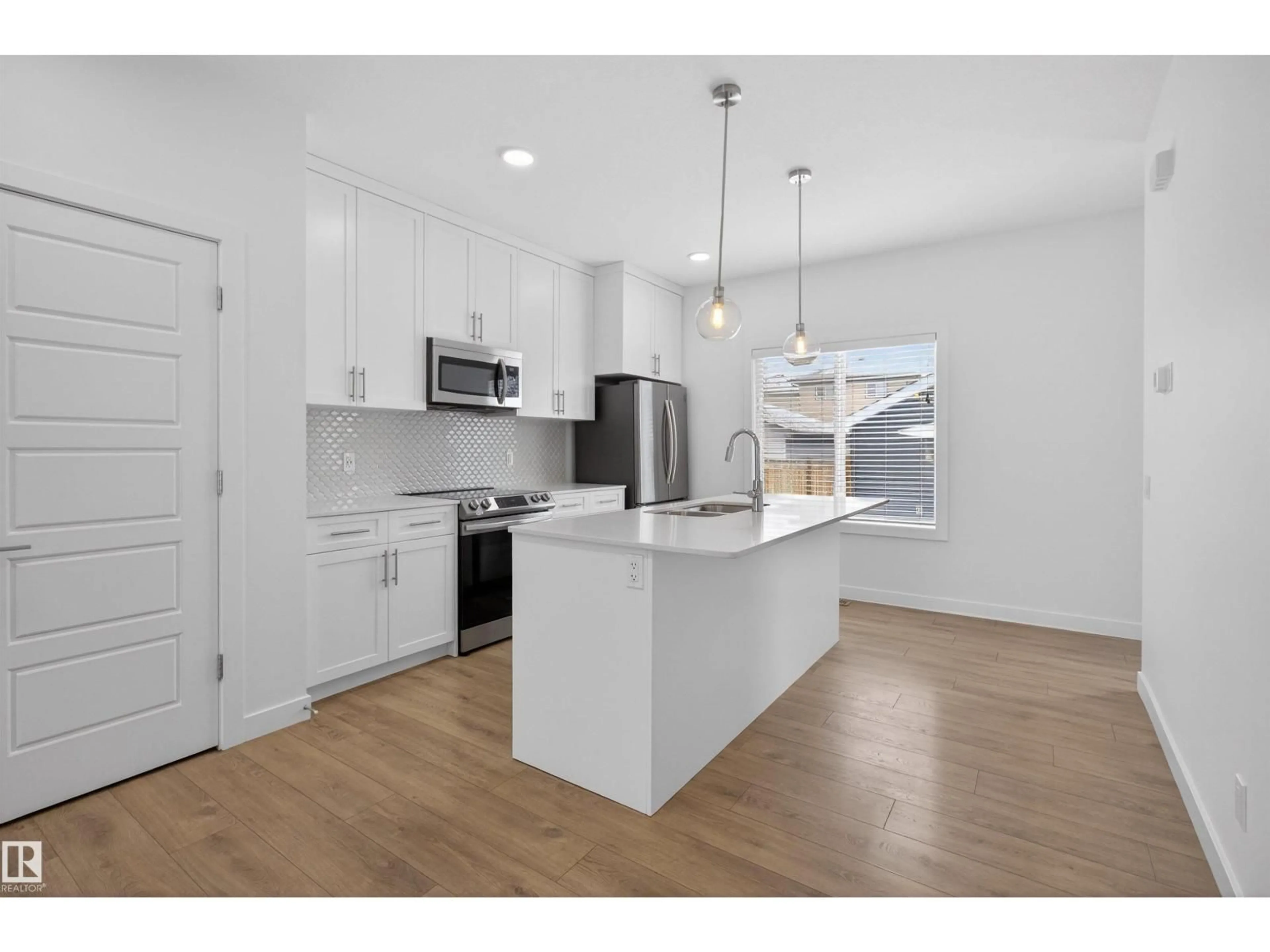 Open concept kitchen, wood/laminate floor for GR SW - 2949 COUGHLAN GREEN, Edmonton Alberta T6W3X6