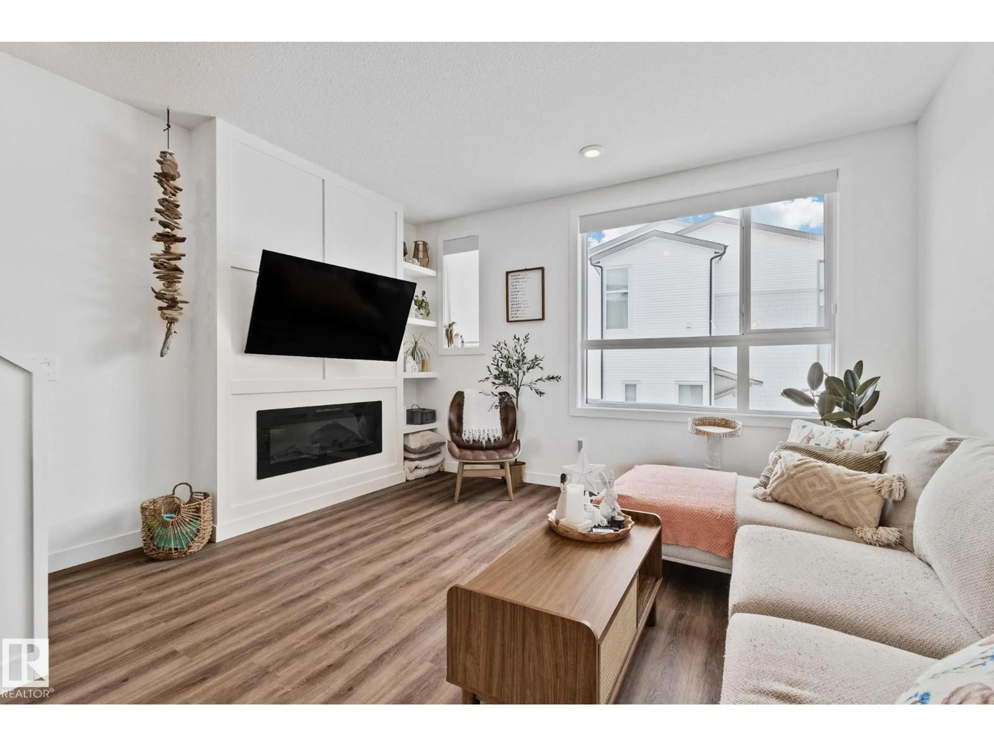 Living room with furniture, wood/laminate floor for 100 - 38 JENSEN LAKES BLVD., St. Albert Alberta T8N7T9