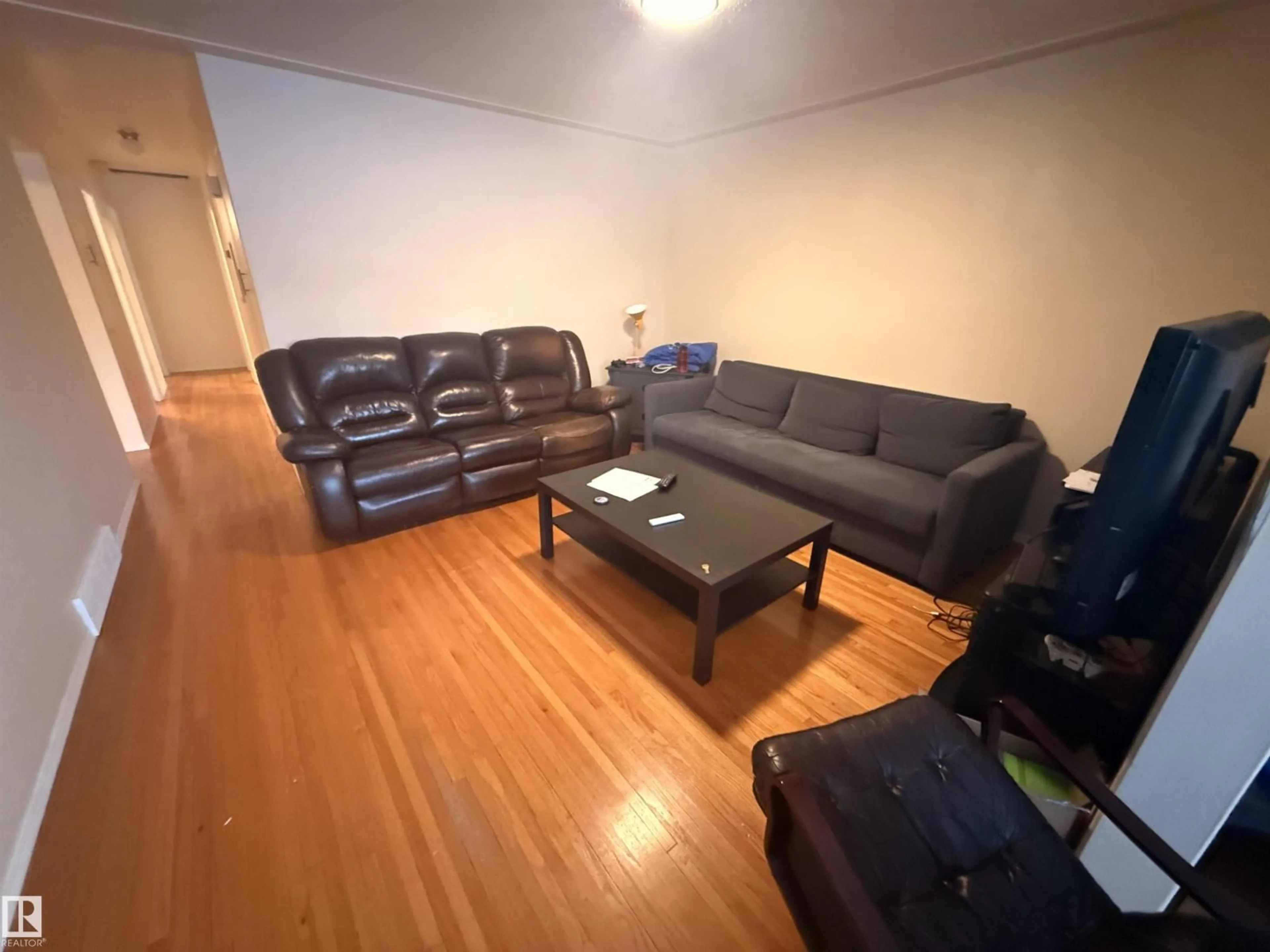 Living room with furniture, unknown for 10545 67 AV, Edmonton Alberta T6H1Z4