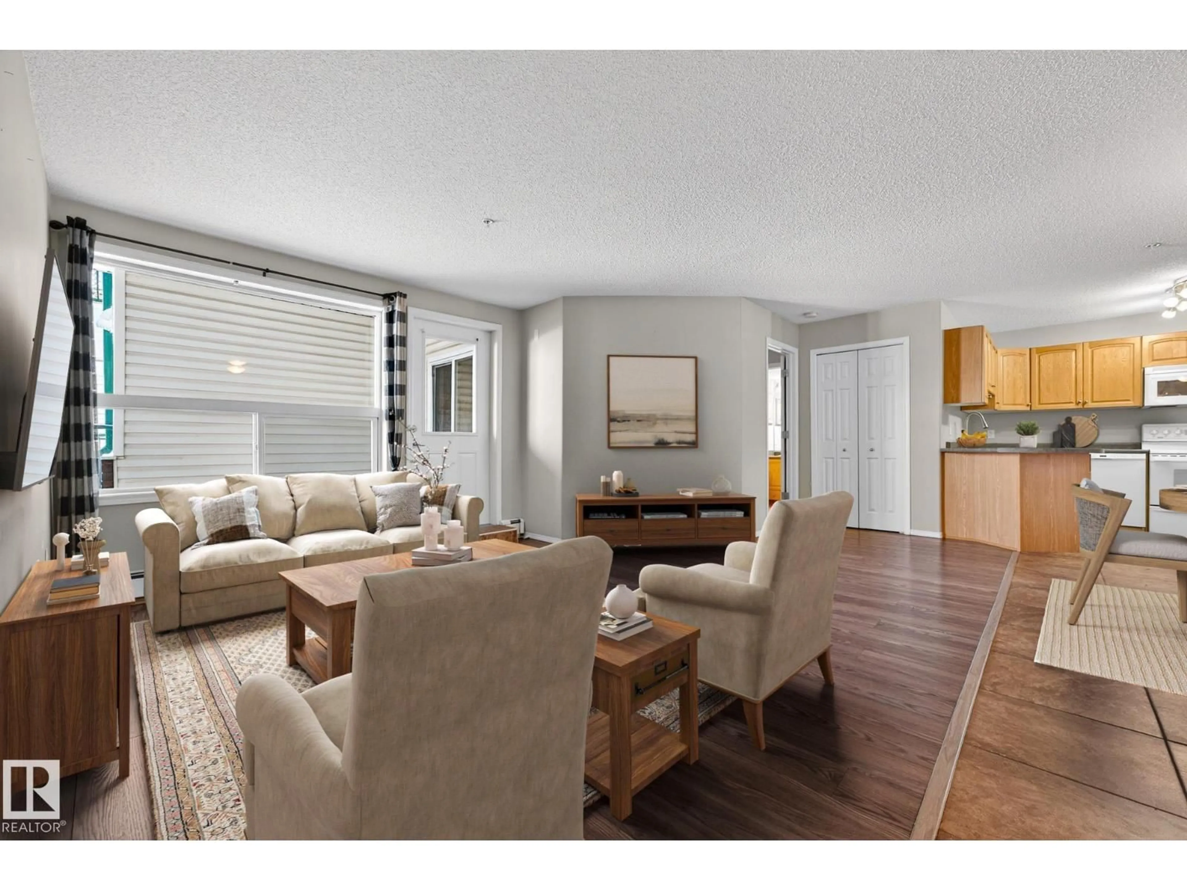 Living room with furniture, wood/laminate floor for NW - 120 13635 34 ST, Edmonton Alberta T5A0C3