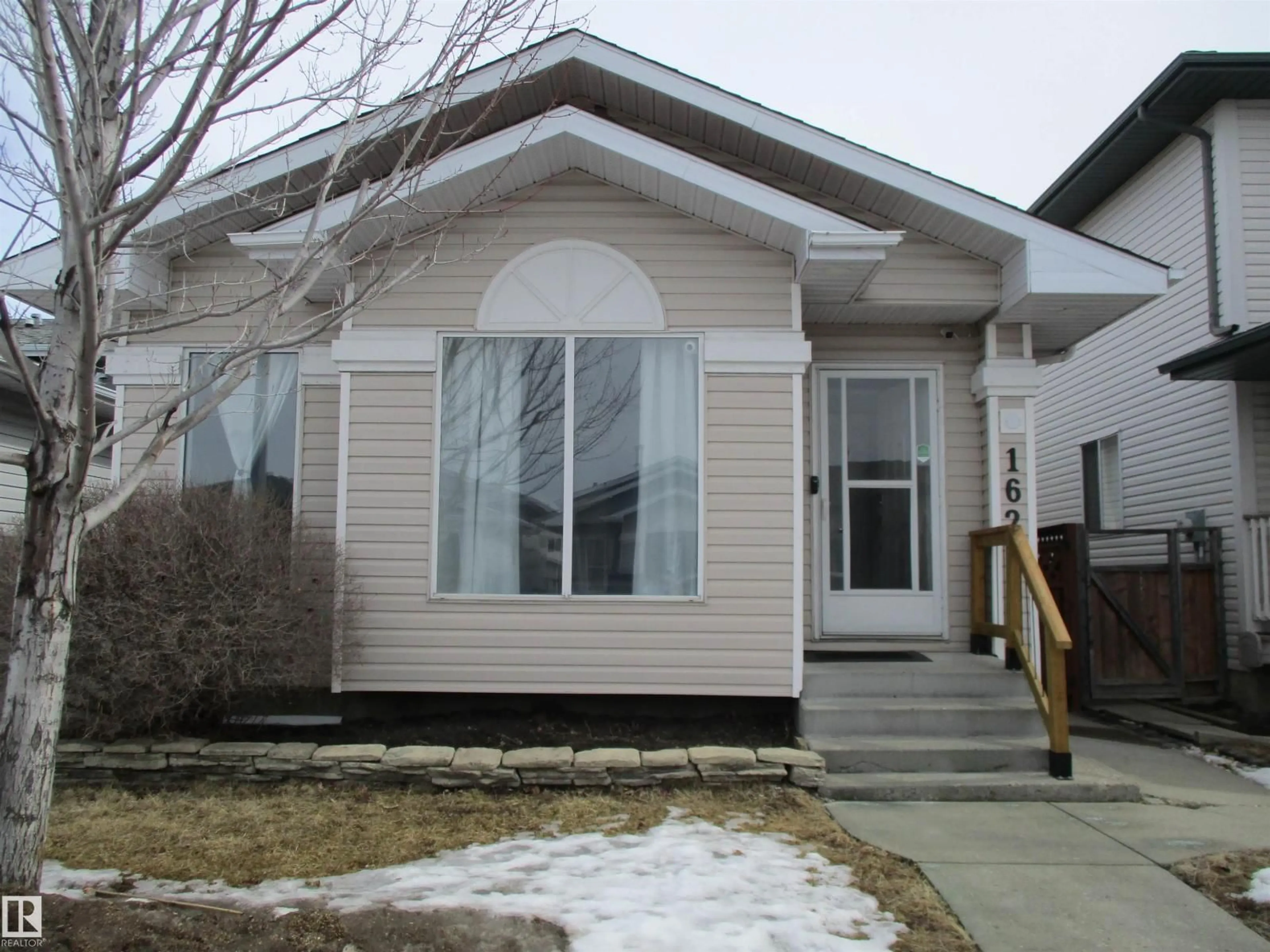 Home with vinyl exterior material, street for NW - 16221 55 A ST, Edmonton Alberta T5Y2T8