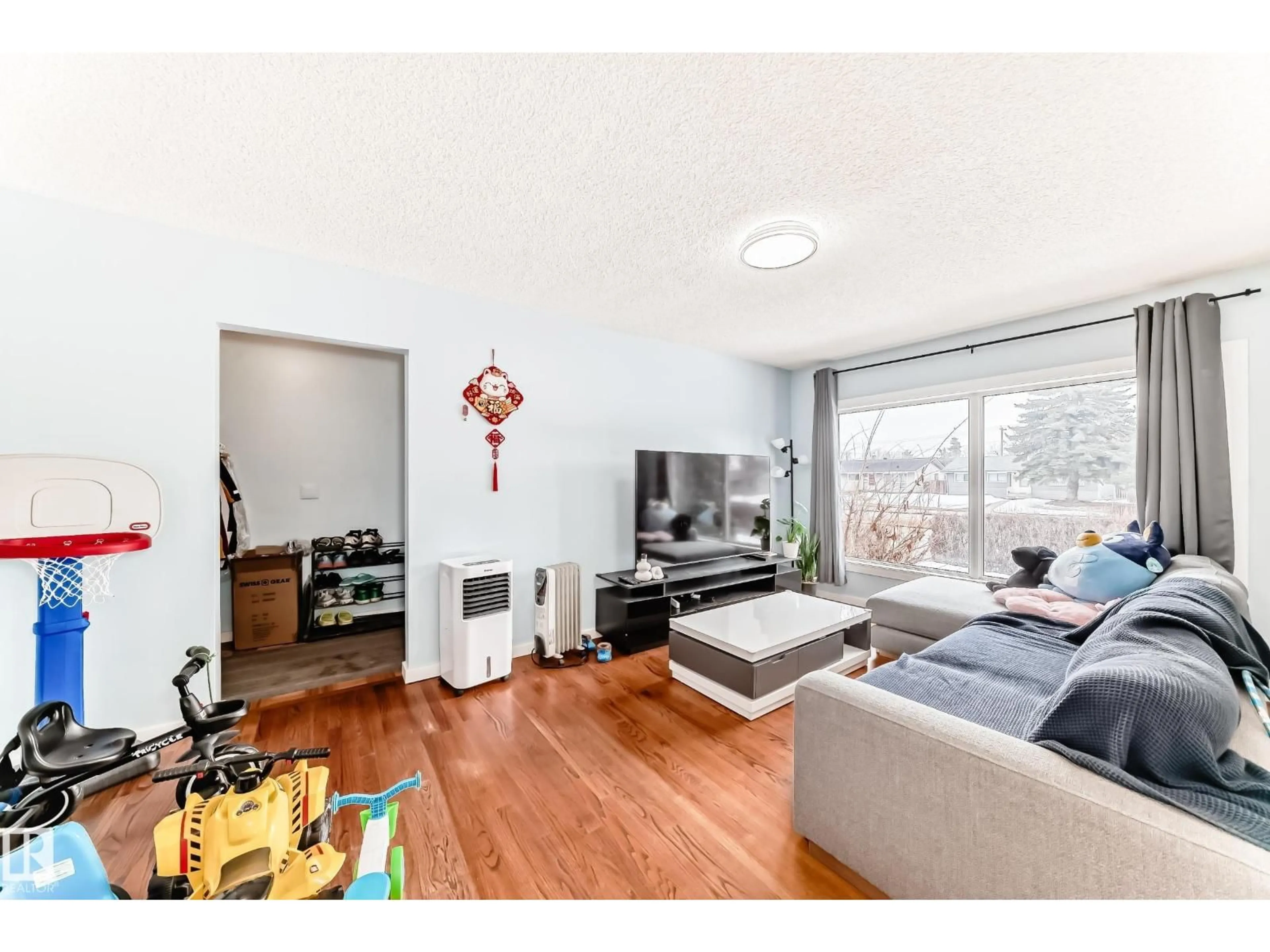 Living room with furniture, wood/laminate floor for 10928 149 ST, Edmonton Alberta T5P1M6