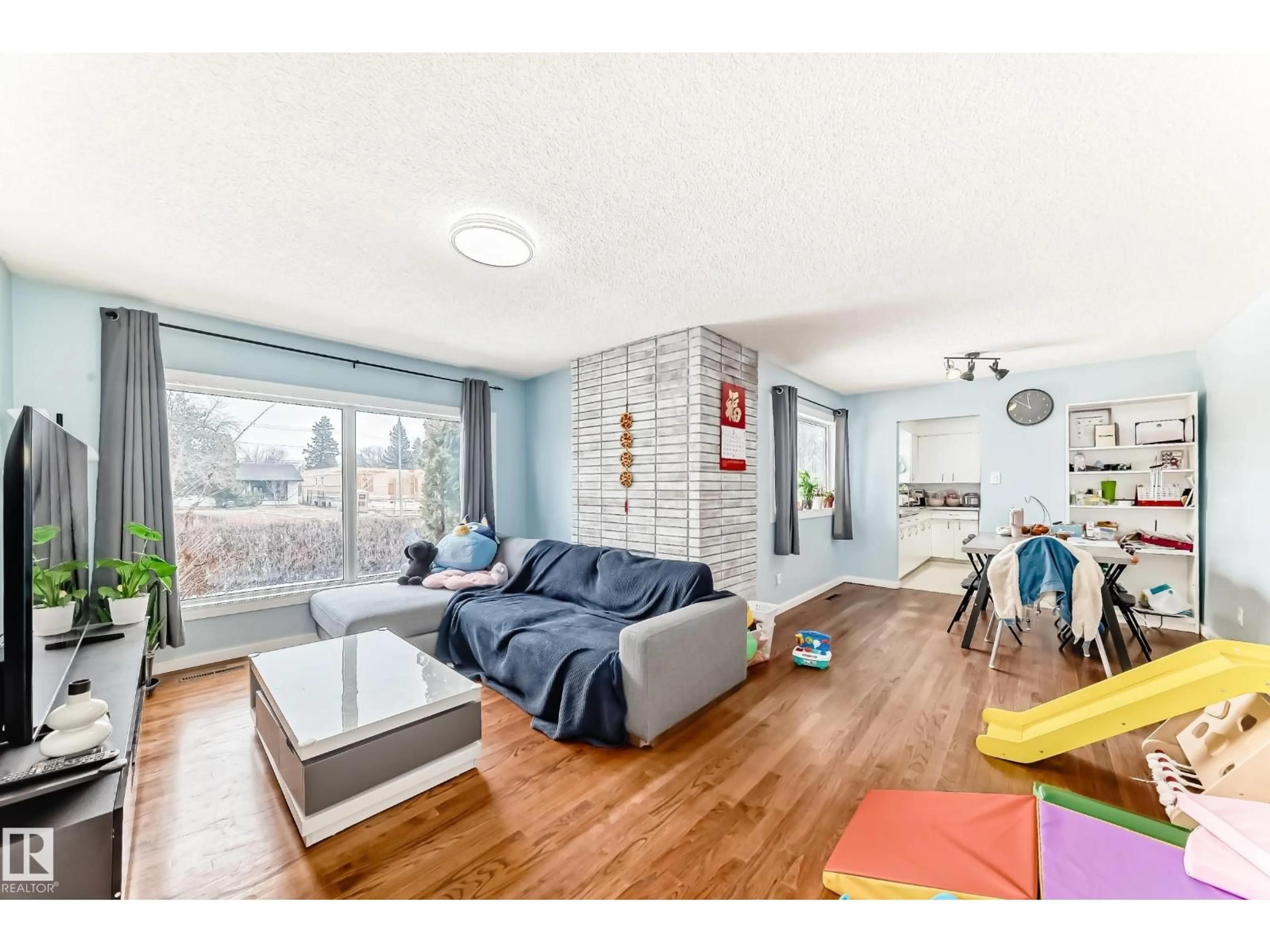 Living room with furniture, wood/laminate floor for 10928 149 ST, Edmonton Alberta T5P1M6