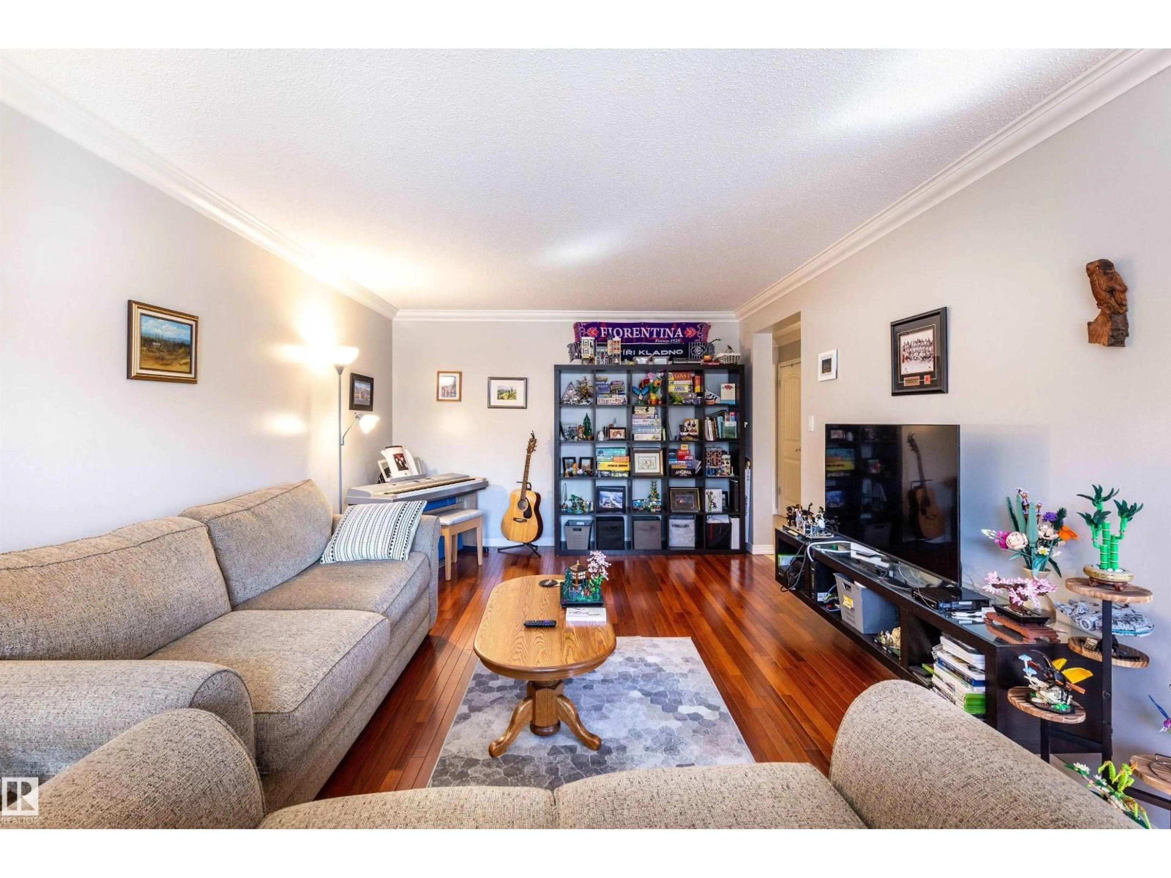 Living room with furniture, wood/laminate floor for 201 - 10720 84 AV, Edmonton Alberta T6E2H9