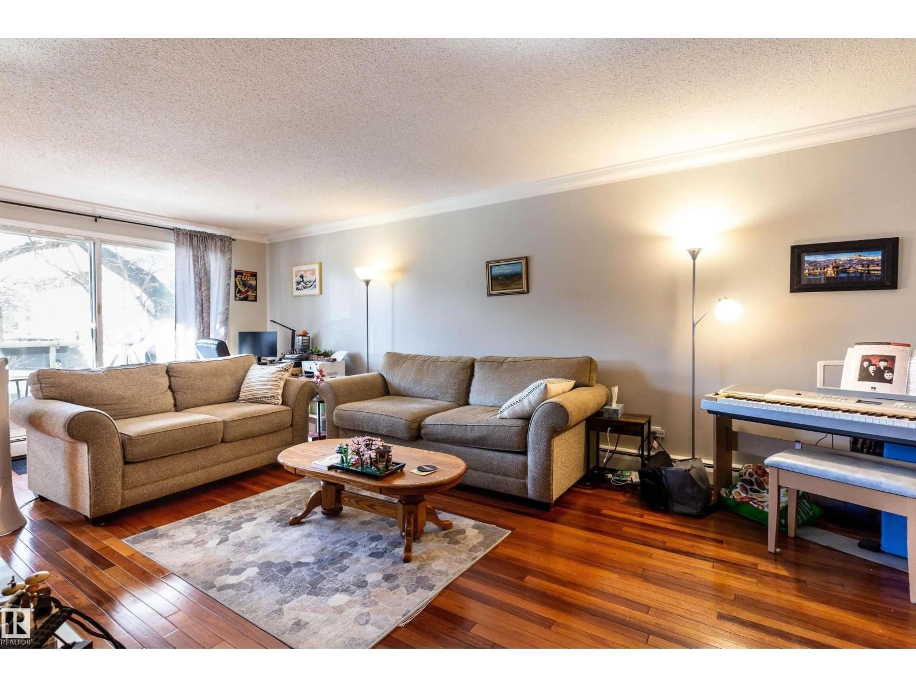 Living room with furniture, wood/laminate floor for 201 - 10720 84 AV, Edmonton Alberta T6E2H9