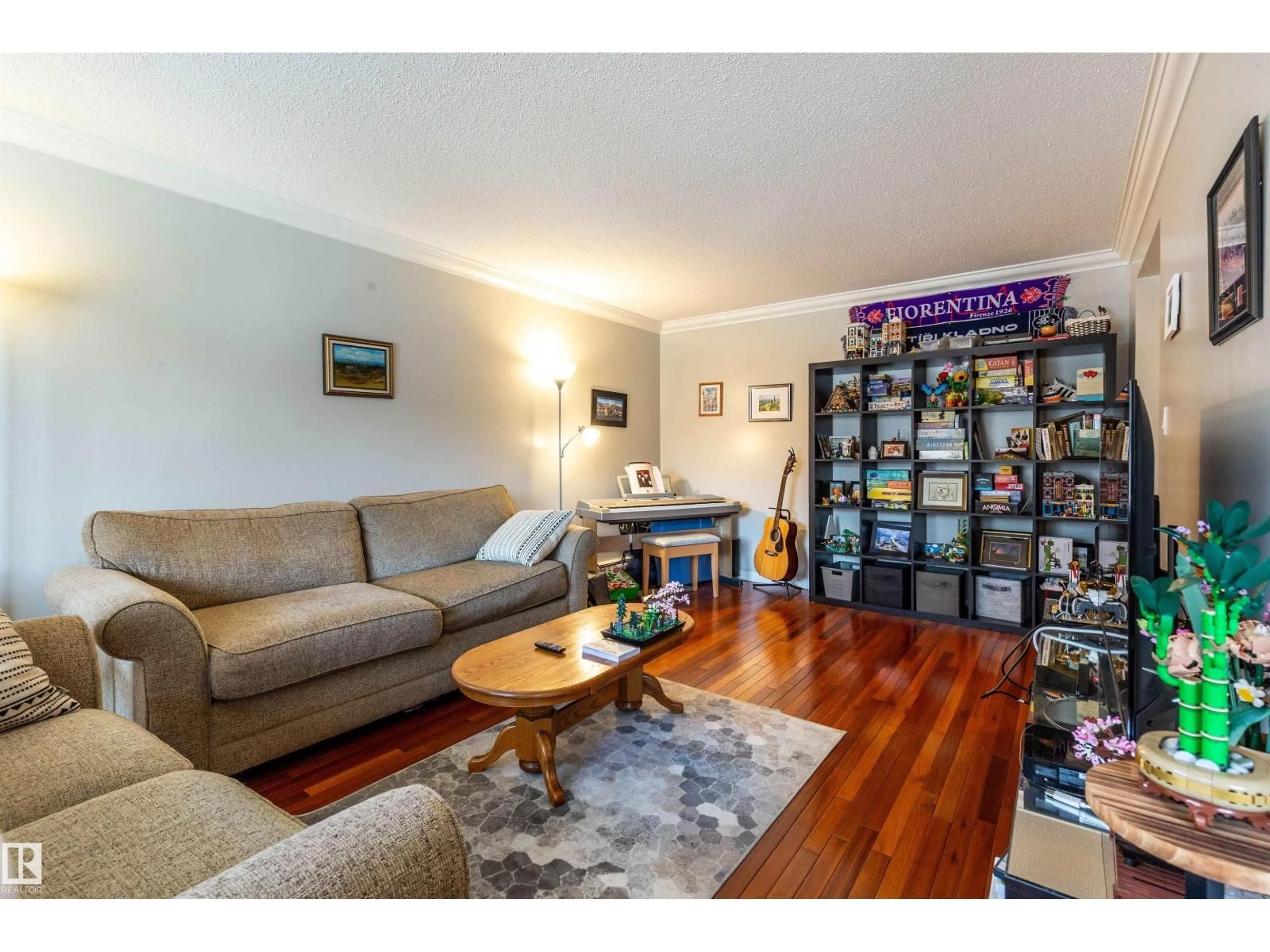 Living room with furniture, wood/laminate floor for 201 - 10720 84 AV, Edmonton Alberta T6E2H9