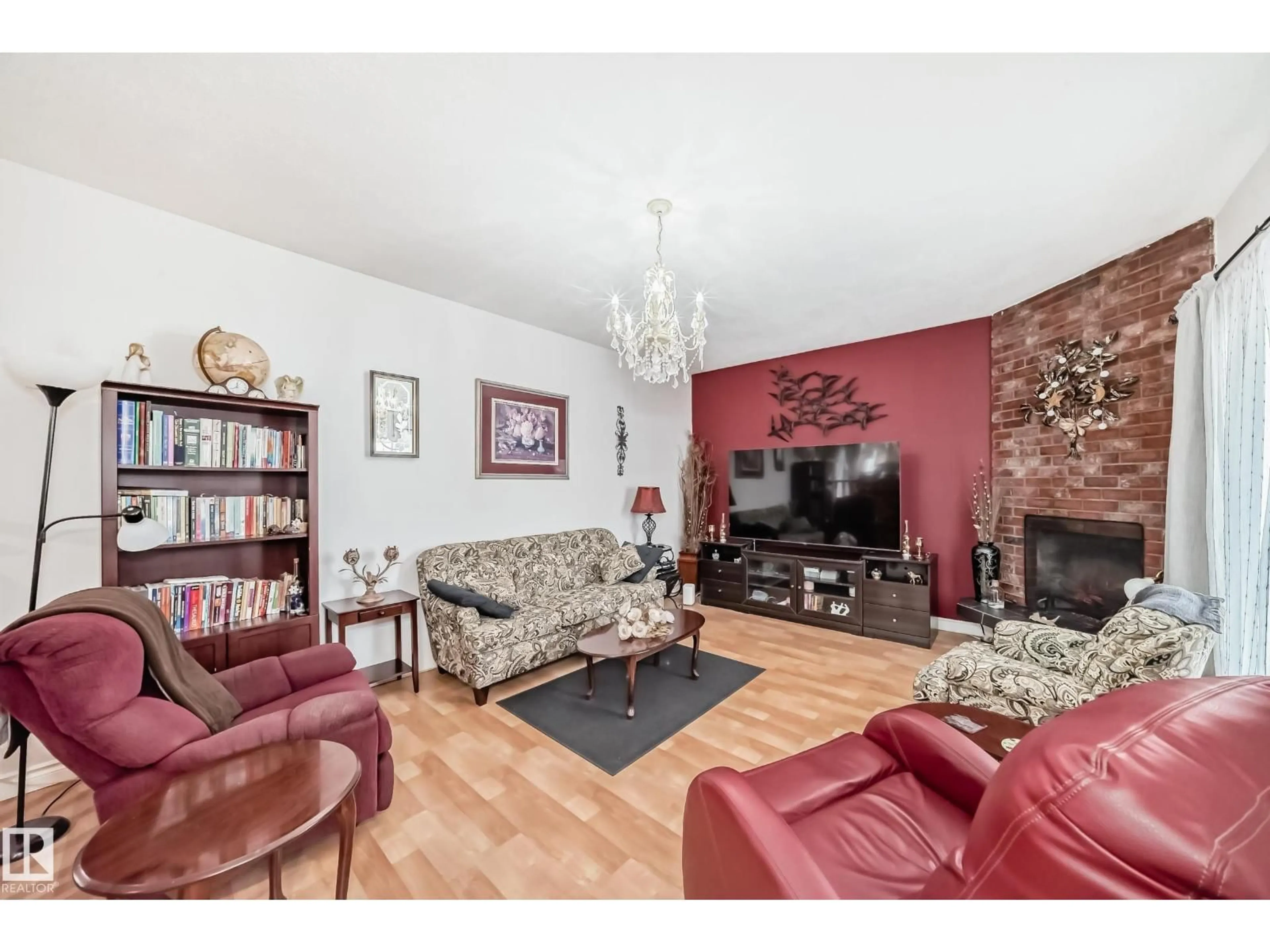 Living room with furniture, wood/laminate floor for 8811 38A AV, Edmonton Alberta T6K0E7