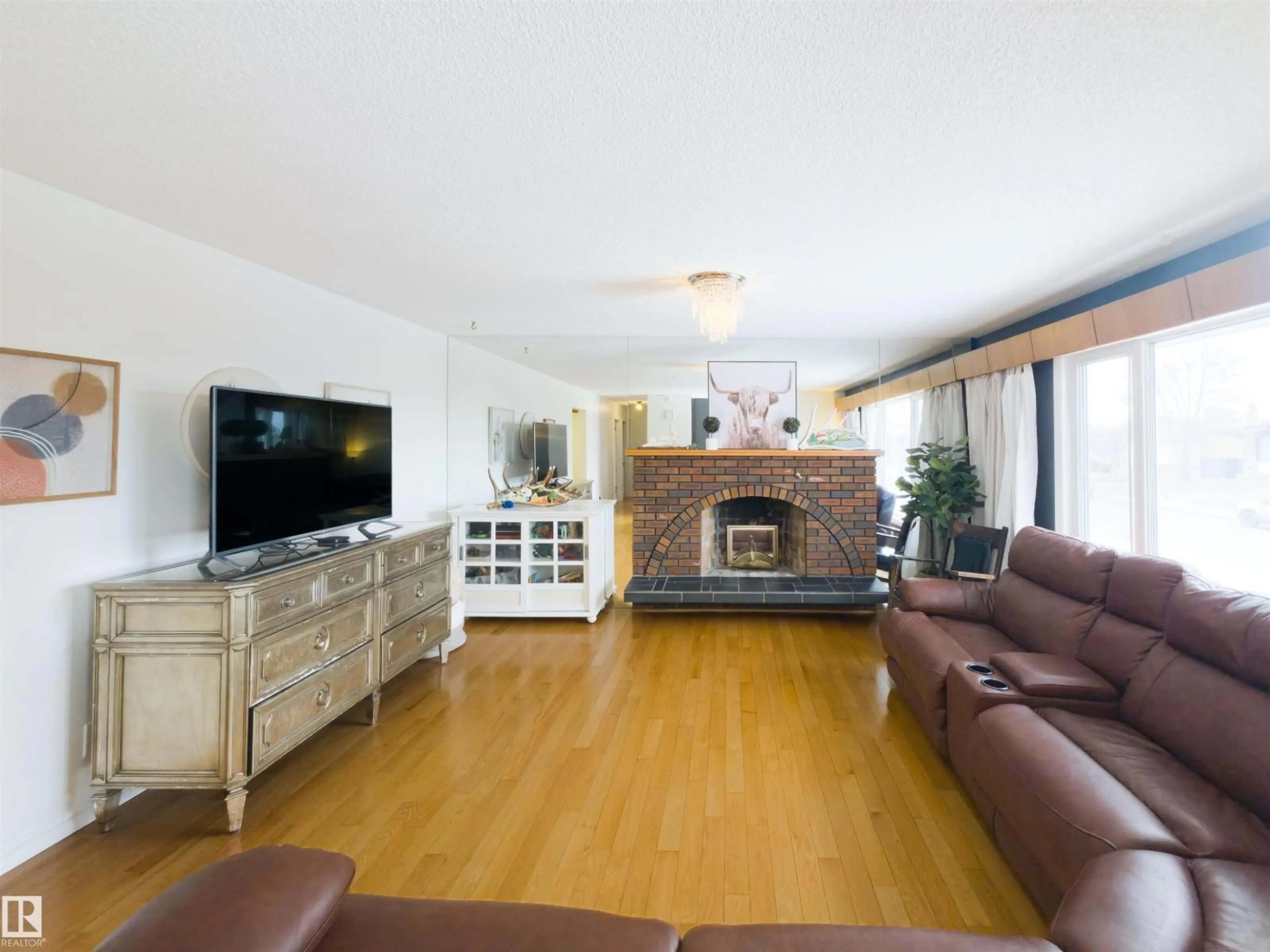 Living room with furniture, wood/laminate floor for 7323 147 AV, Edmonton Alberta T5C2T1