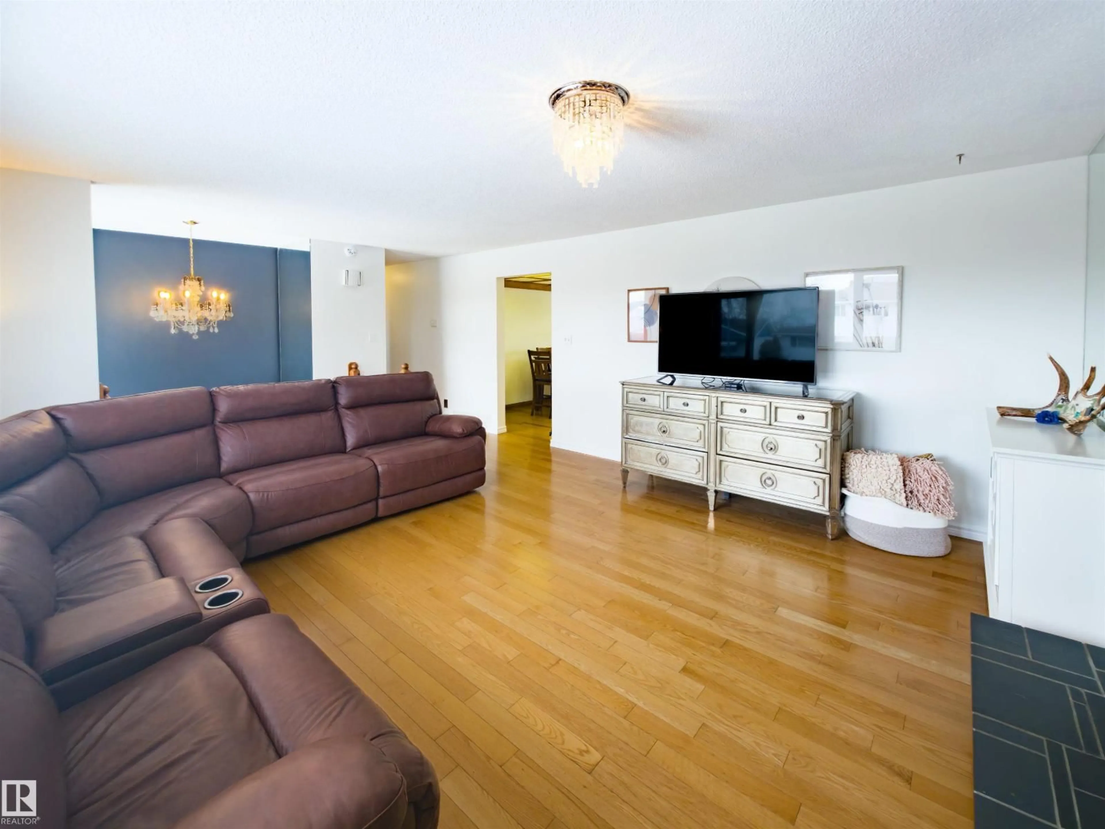 Living room with furniture, wood/laminate floor for 7323 147 AV, Edmonton Alberta T5C2T1