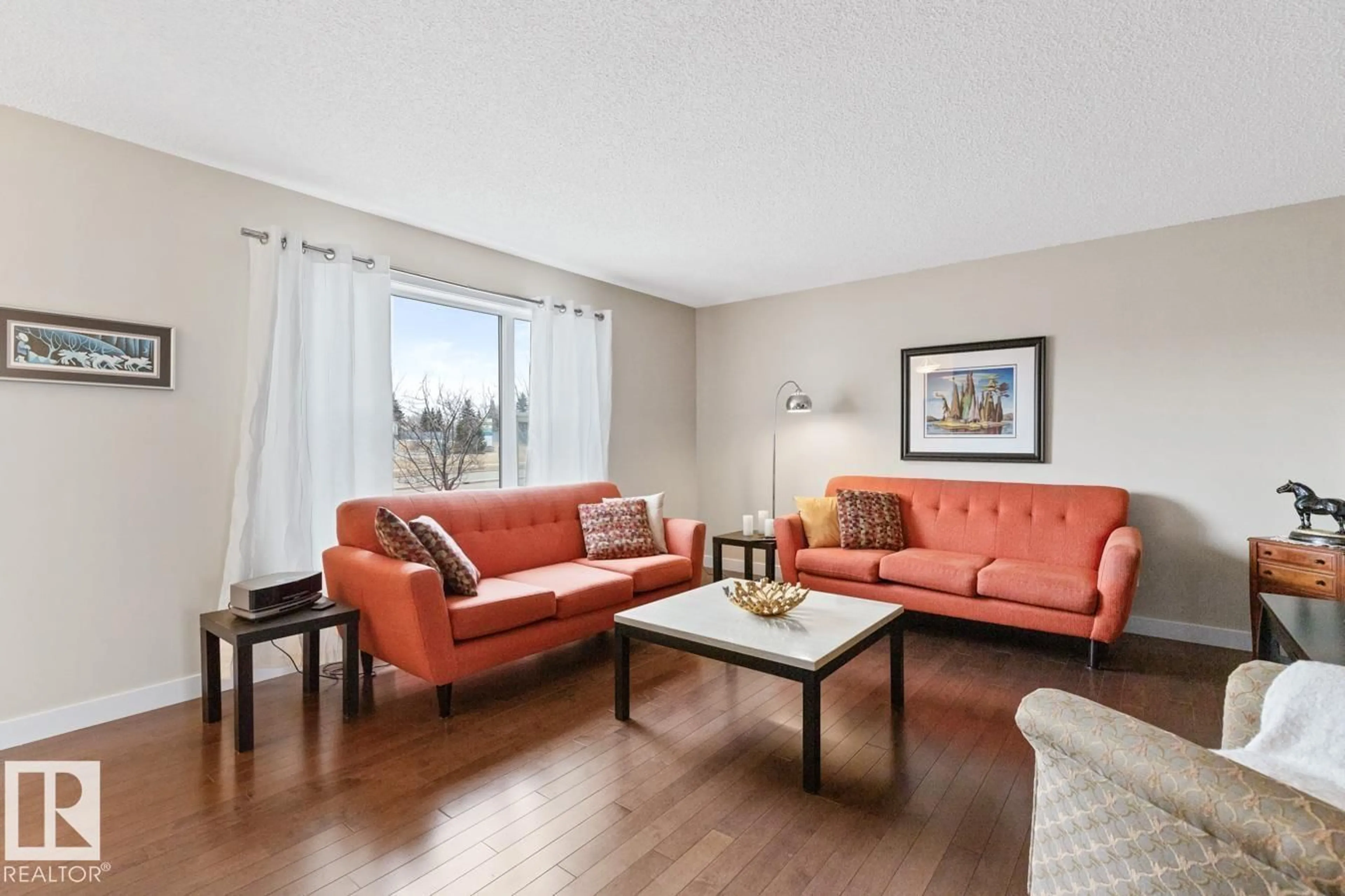 Living room with furniture, wood/laminate floor for 46 - 301 PALISADES WY, Sherwood Park Alberta T8H0T4