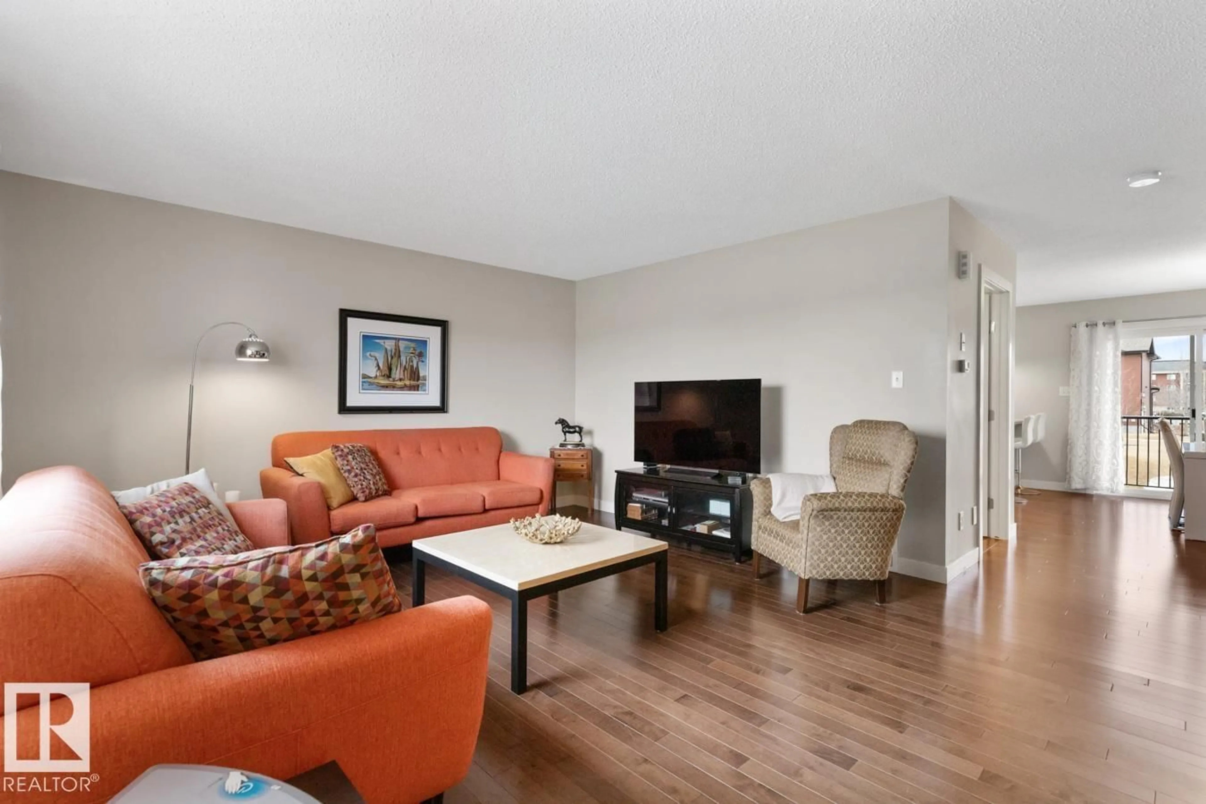 Living room with furniture, wood/laminate floor for 46 - 301 PALISADES WY, Sherwood Park Alberta T8H0T4