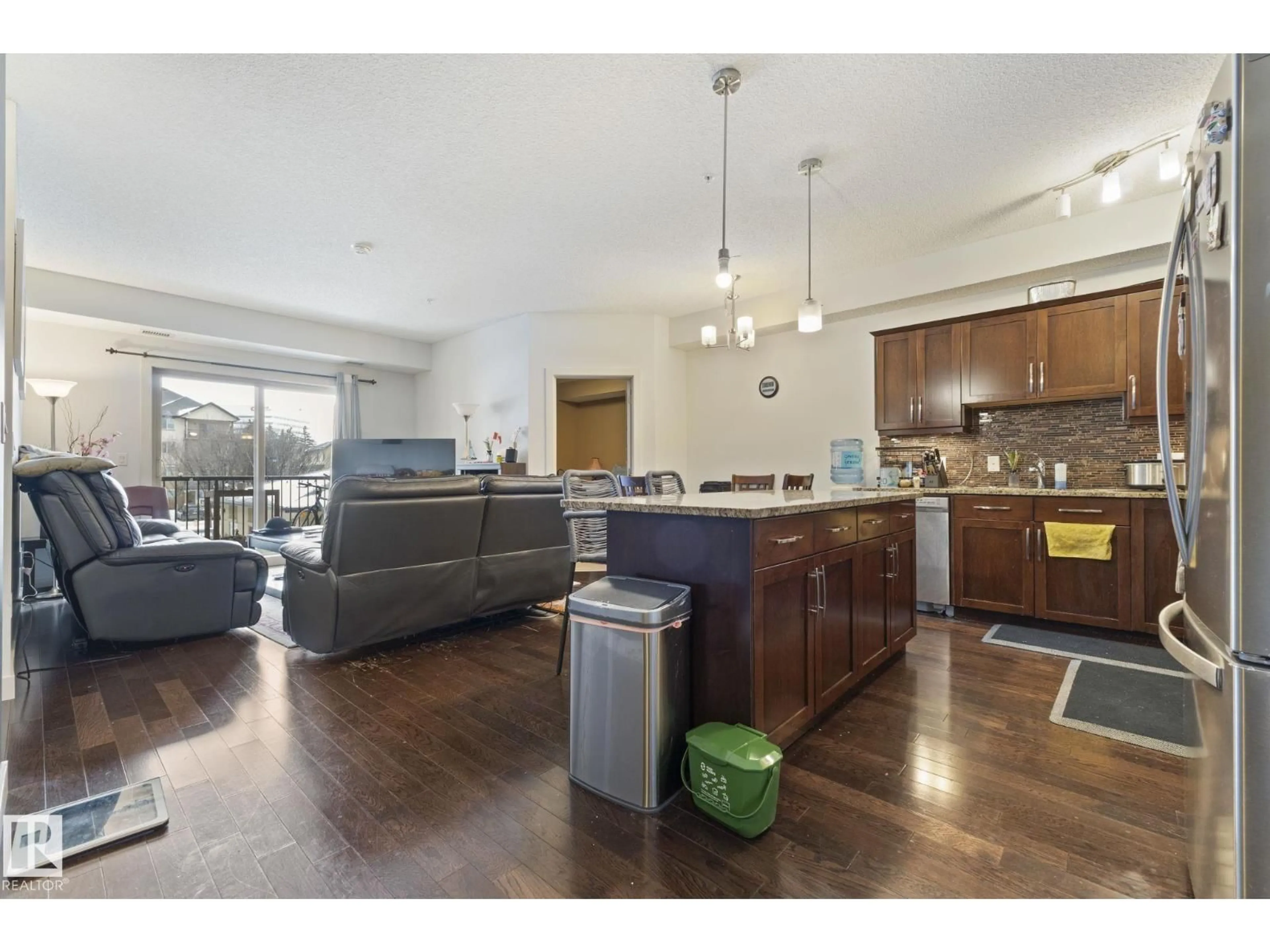 Open concept kitchen, wood/laminate floor for #214 - 10530 56 AV, Edmonton Alberta T6H0X7