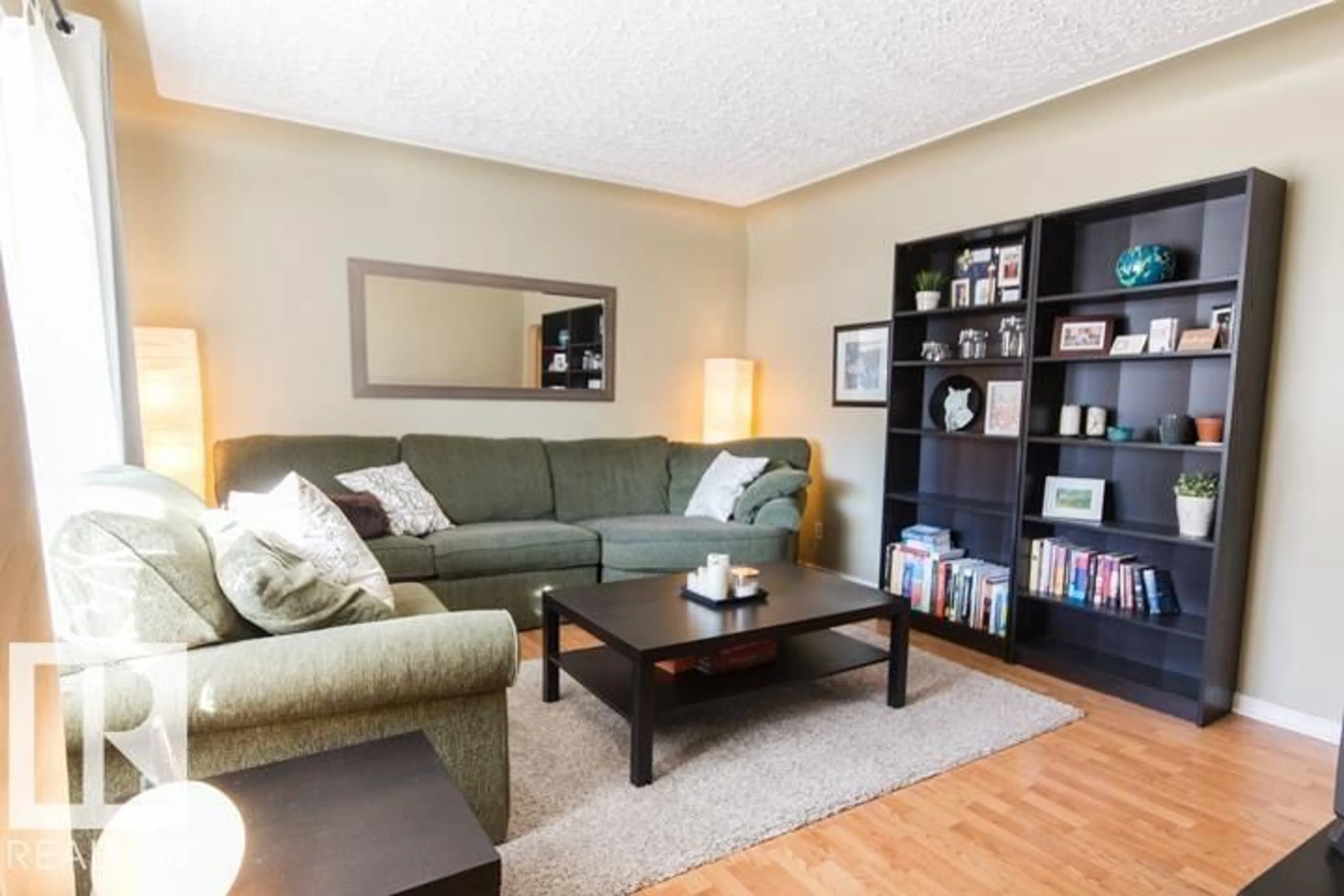 Living room with furniture, wood/laminate floor for 10806 64 AV, Edmonton Alberta T6H1T2
