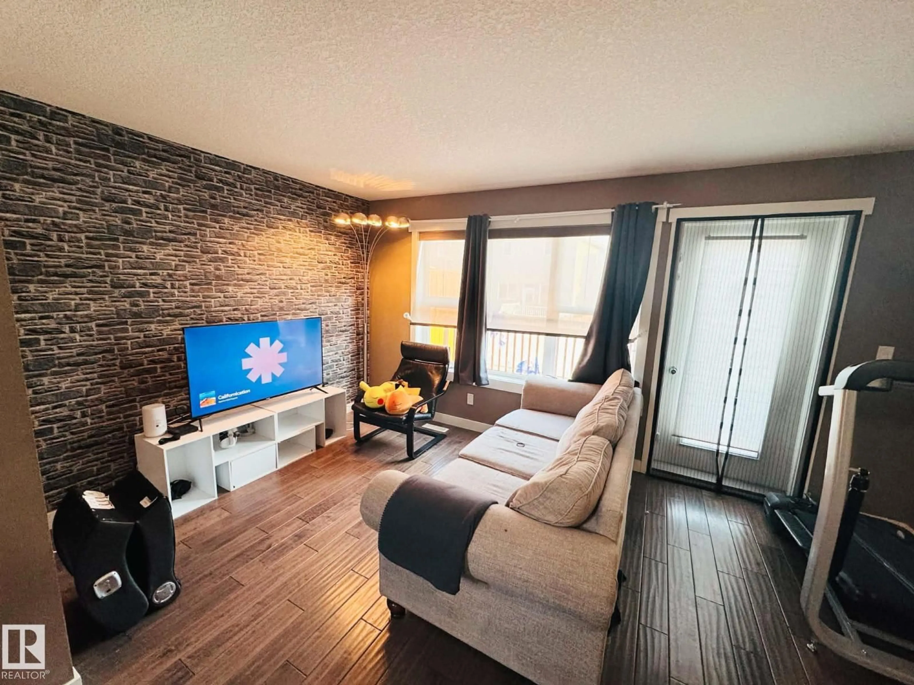 Living room with furniture, wood/laminate floor for 311 - 401 SOUTHFORK DR, Leduc Alberta T9E0X1