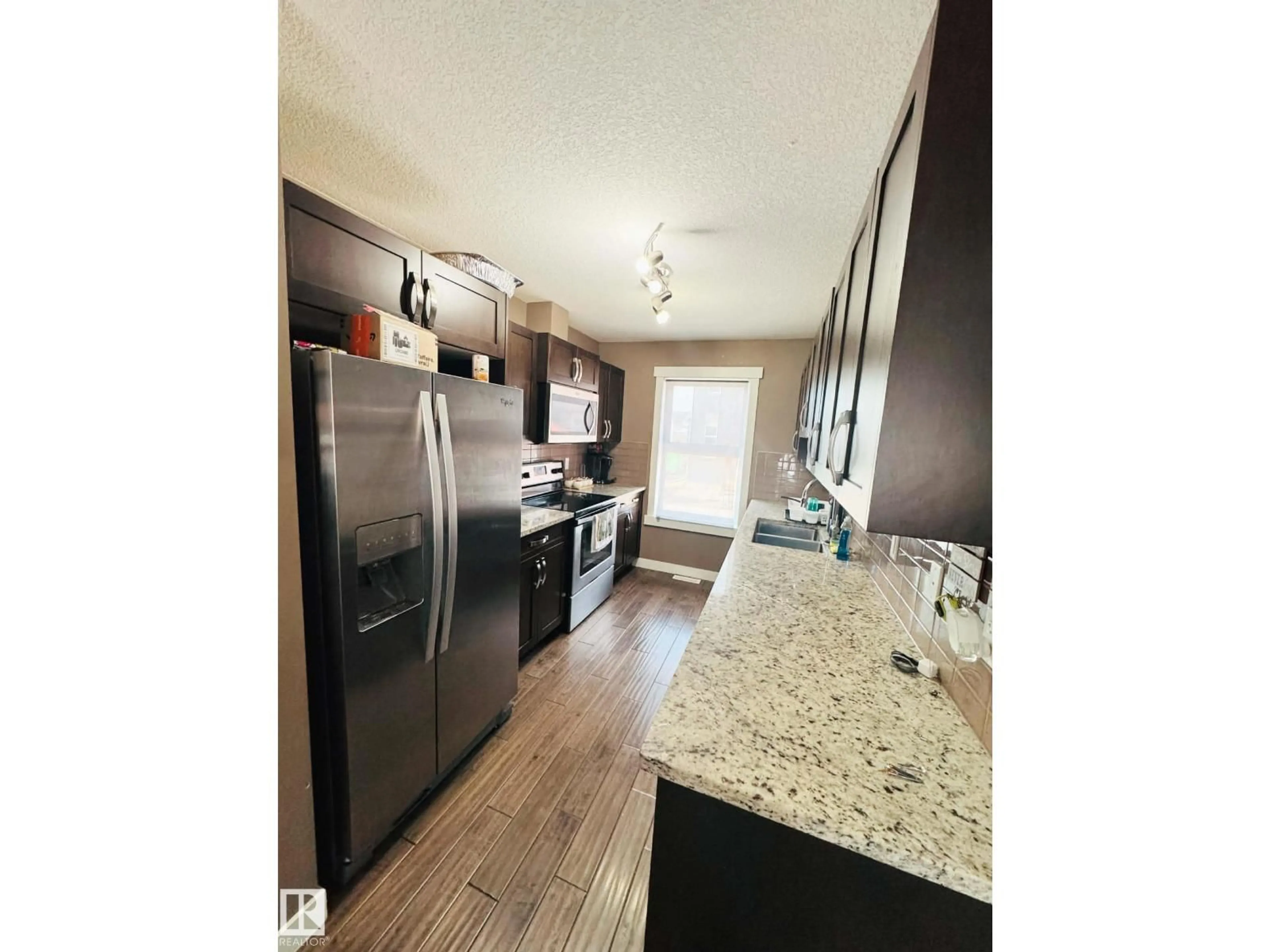 Open concept kitchen, wood/laminate floor for 311 - 401 SOUTHFORK DR, Leduc Alberta T9E0X1
