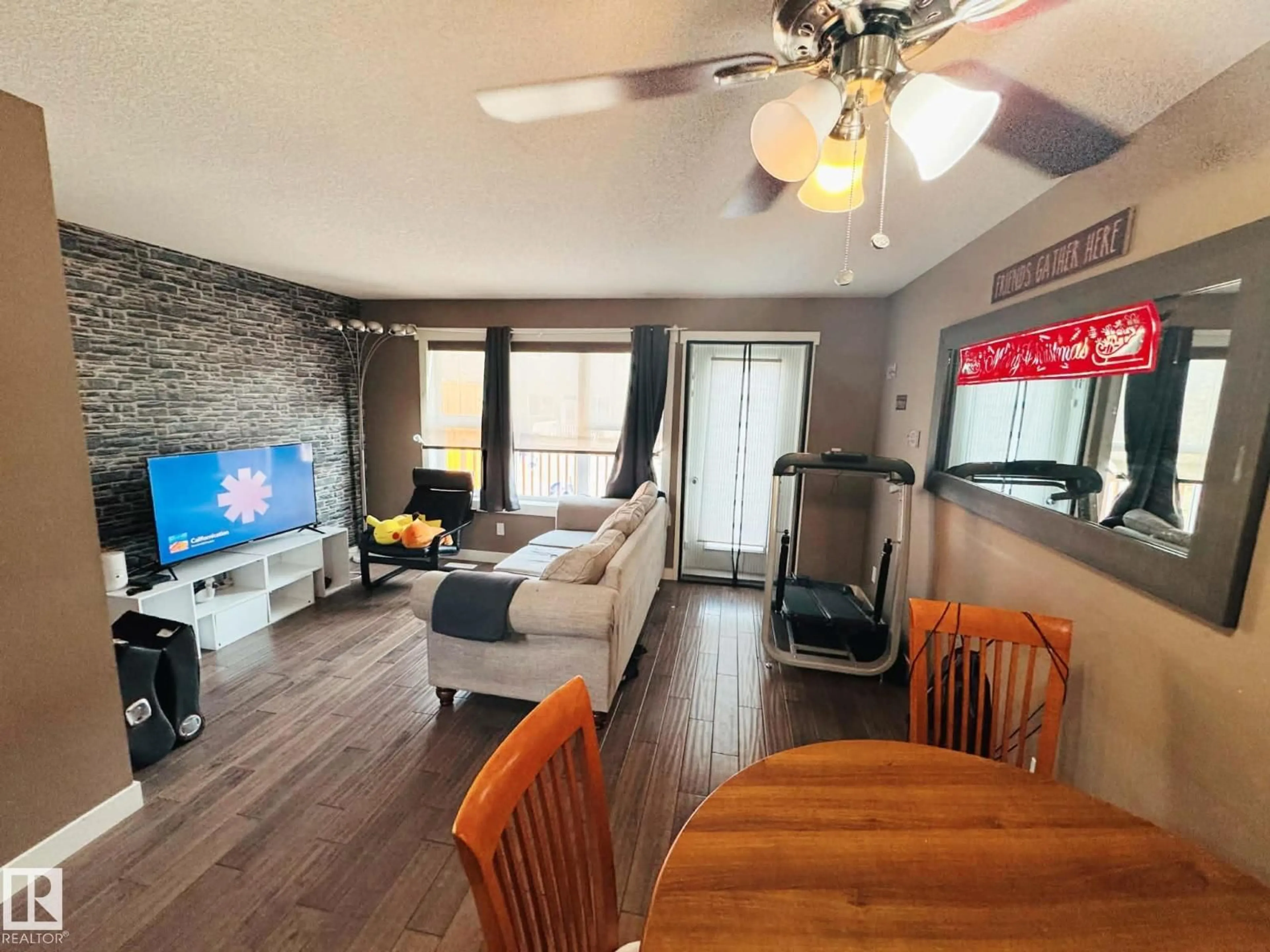 Living room with furniture, wood/laminate floor for 311 - 401 SOUTHFORK DR, Leduc Alberta T9E0X1