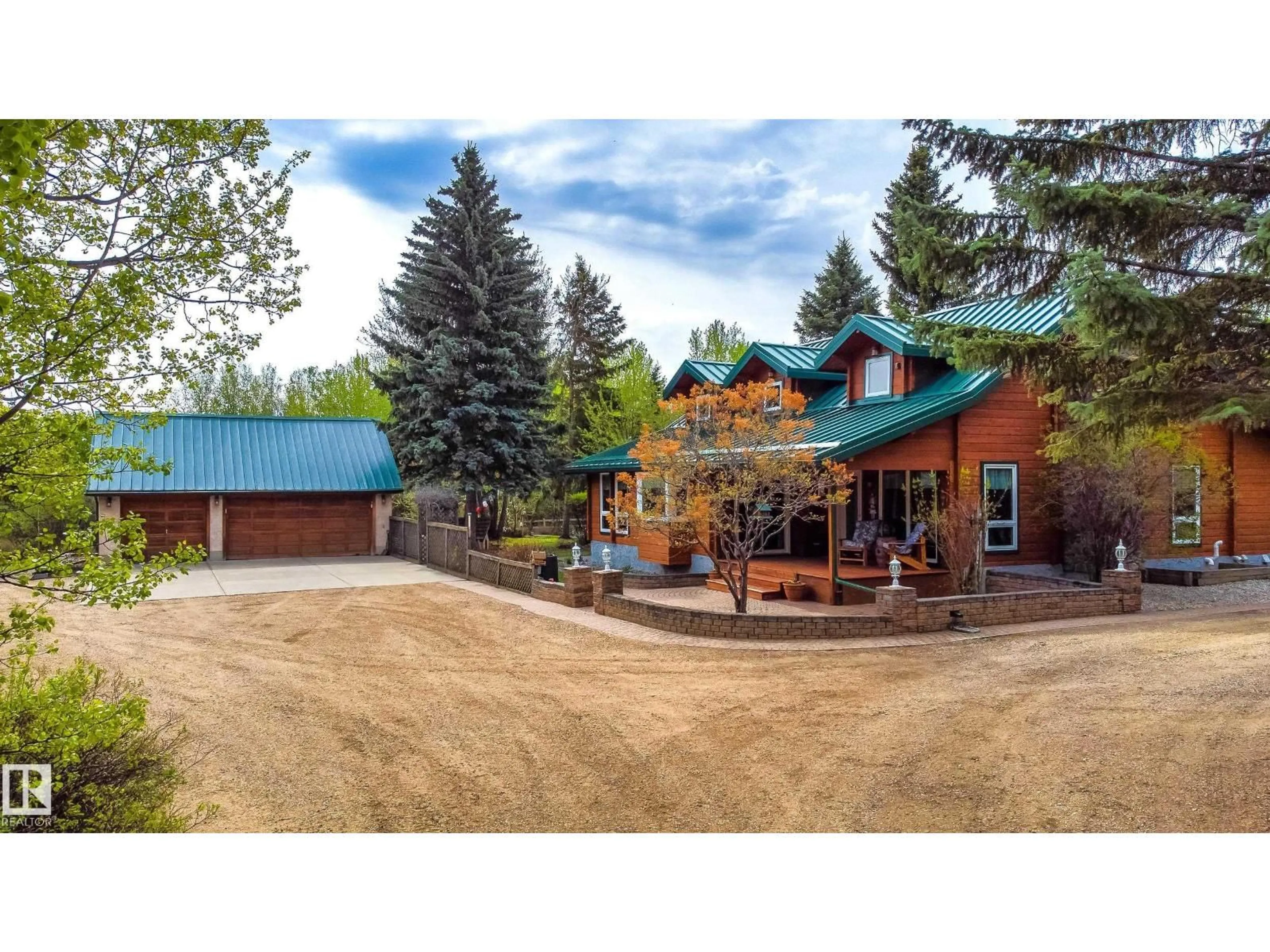 A pic from outside/outdoor area/front of a property/back of a property/a pic from drone, mountain view for 130 50531 RGE RD 234, Rural Leduc County Alberta T4X0L7