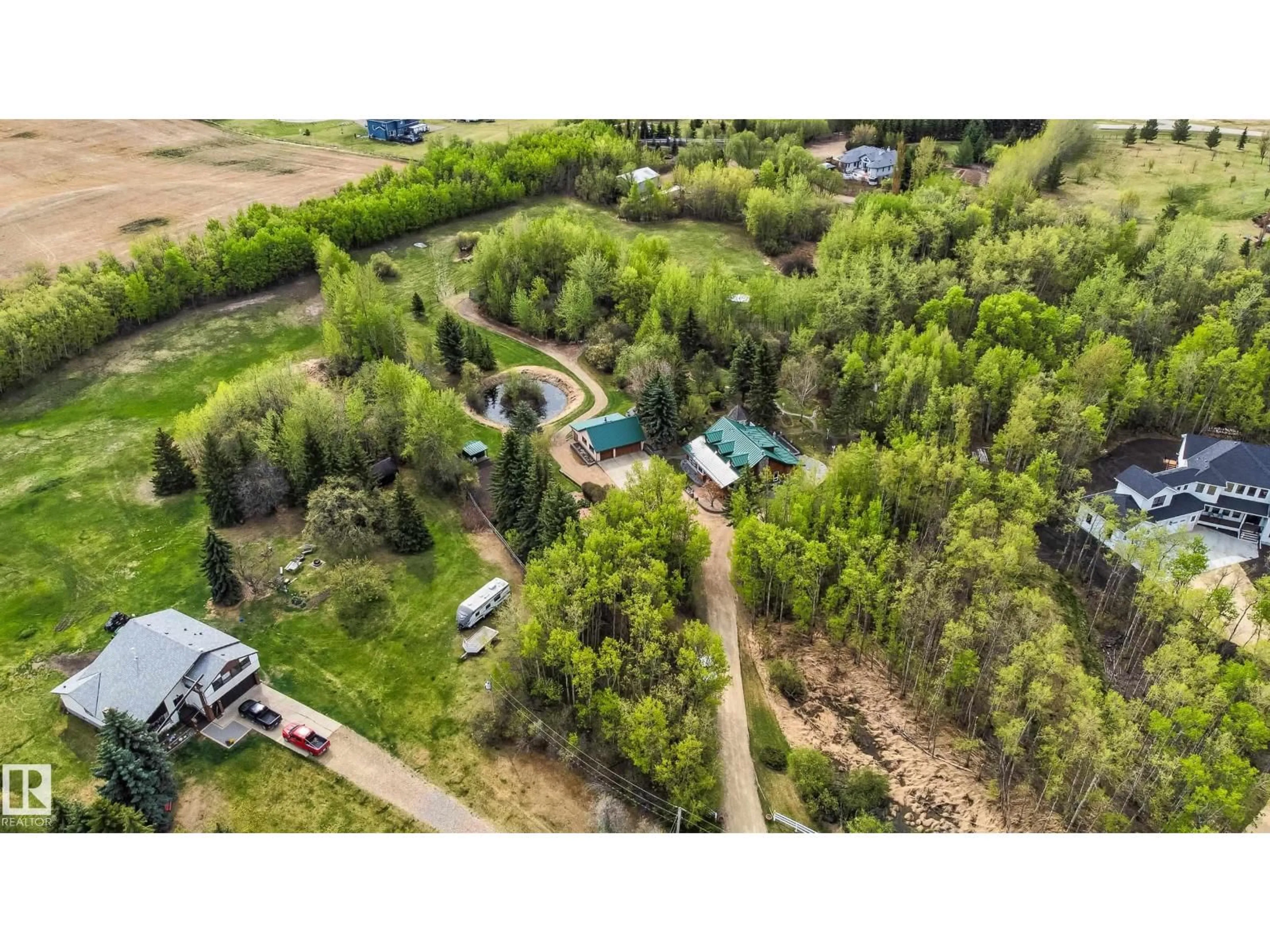 A pic from outside/outdoor area/front of a property/back of a property/a pic from drone, forest/trees view for 130 50531 RGE RD 234, Rural Leduc County Alberta T4X0L7