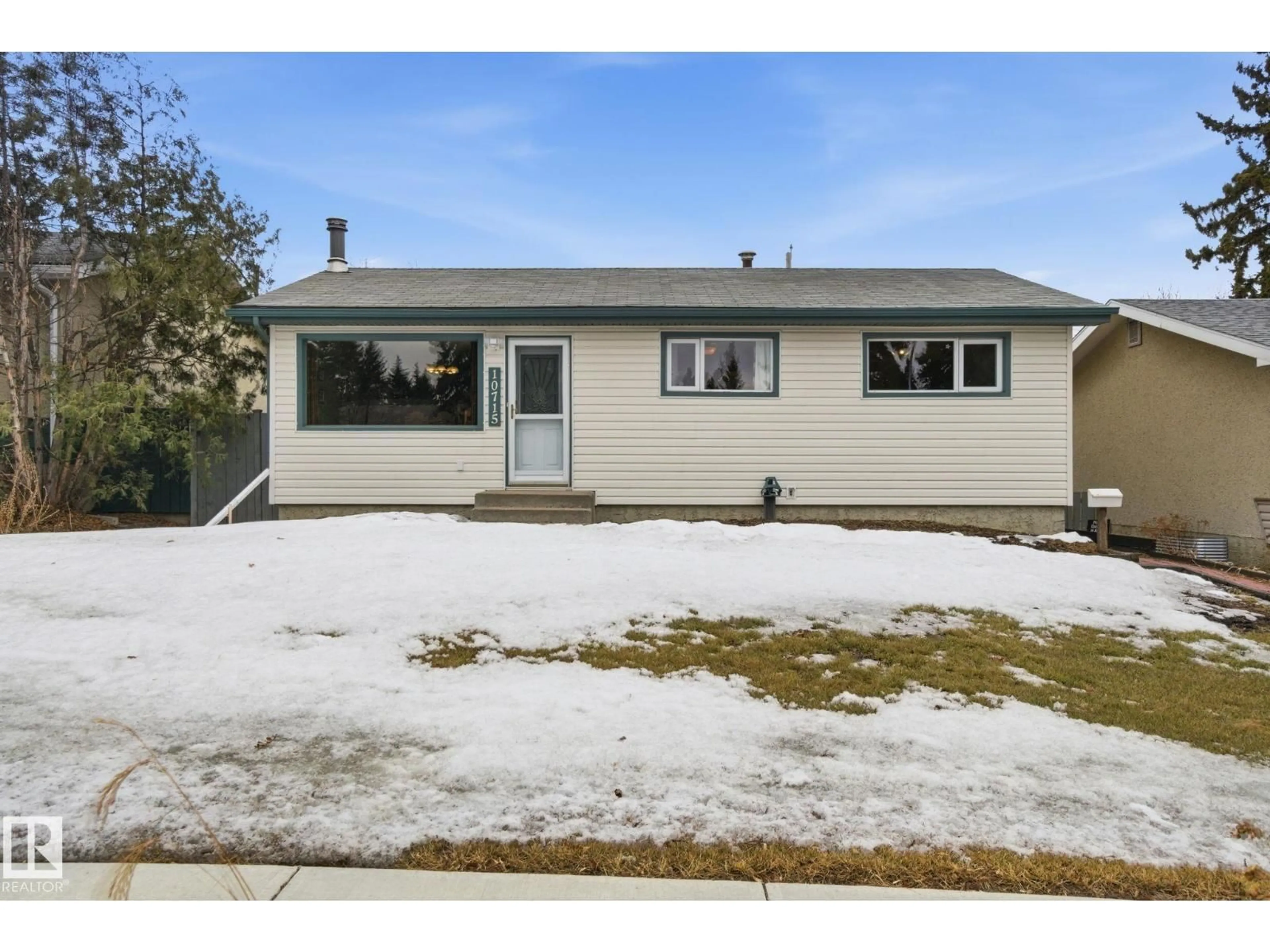 Home with vinyl exterior material, street for 10715 52 AV, Edmonton Alberta T6H0P2