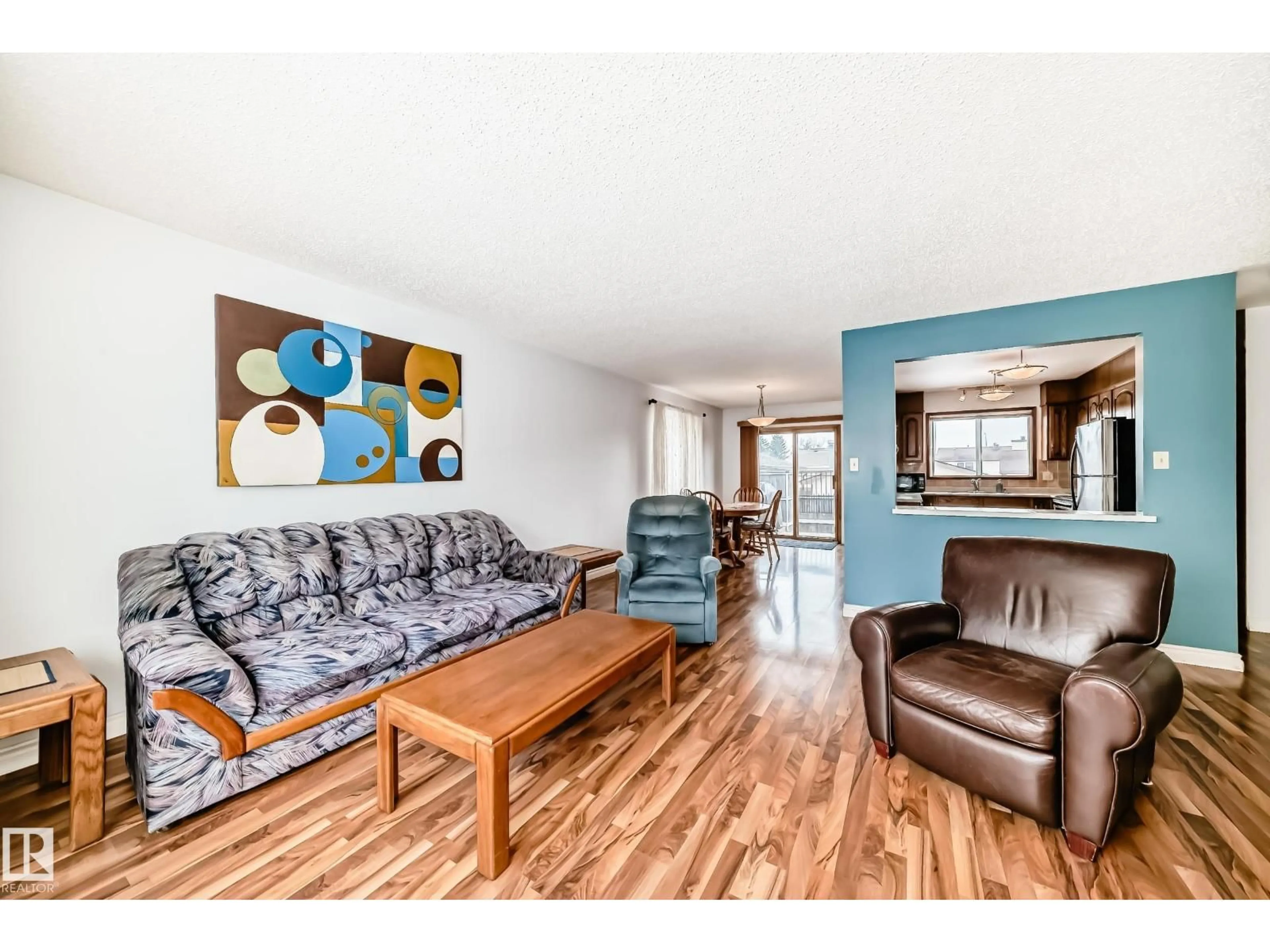 Living room with furniture, wood/laminate floor for 18507 98 AV, Edmonton Alberta T5T3E6