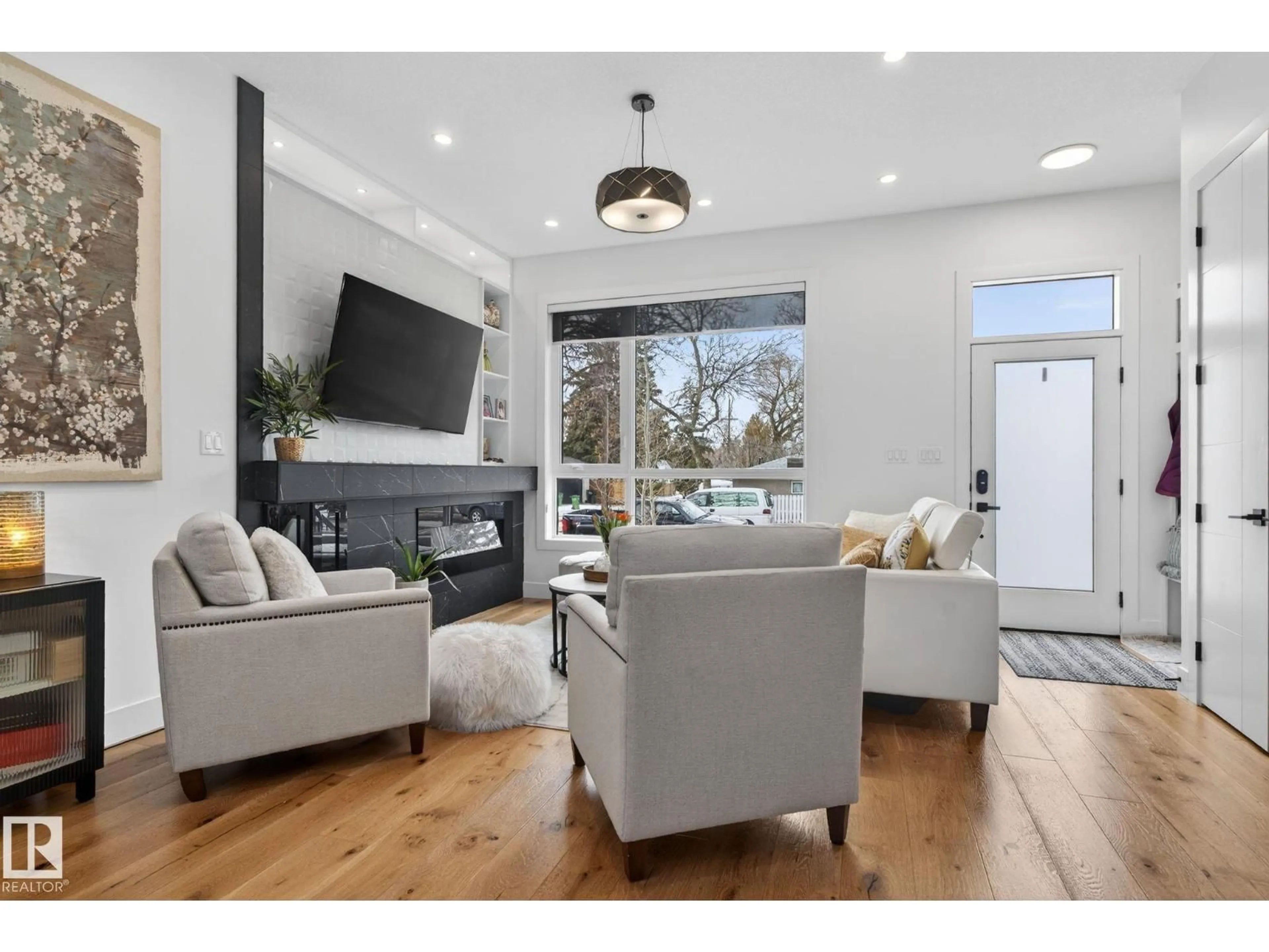 Living room with furniture, wood/laminate floor for 8405 77 ST, Edmonton Alberta T6C2L7