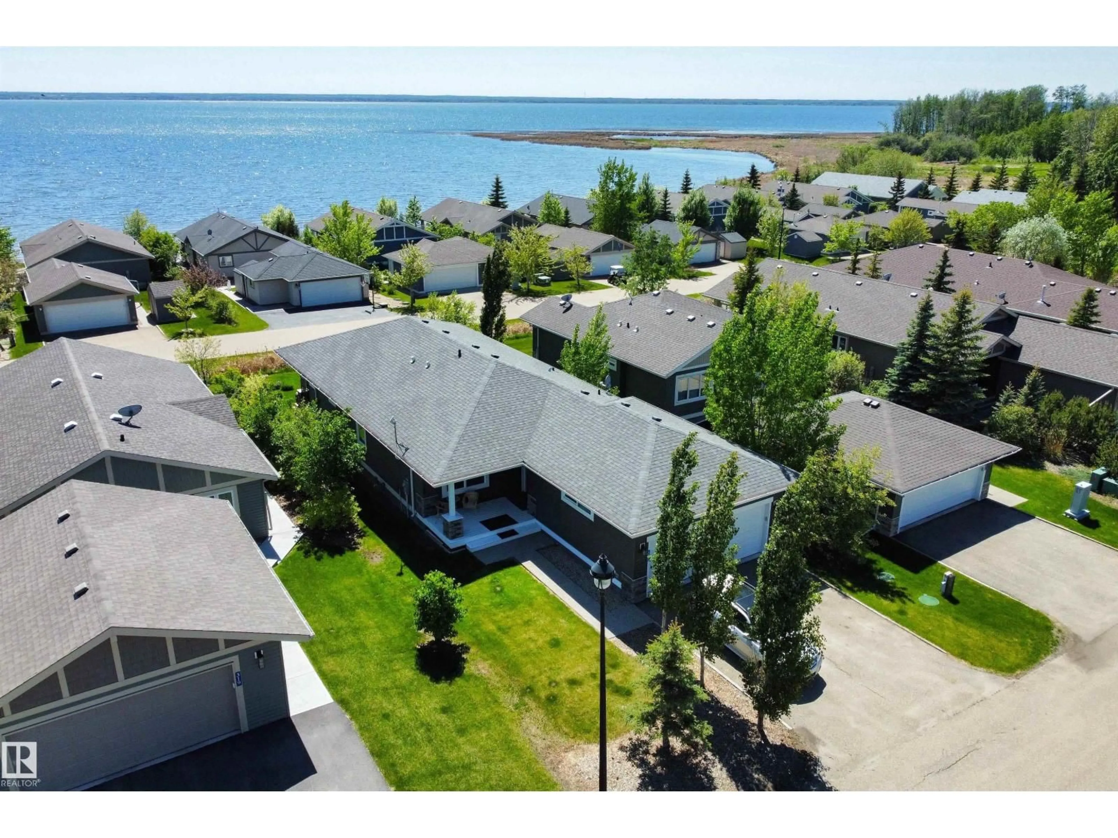 A pic from outside/outdoor area/front of a property/back of a property/a pic from drone, water/lake/river/ocean view for STE. 55101 - 321 ANNE TR, Rural Lac Ste. Anne County Alberta T0E1A1