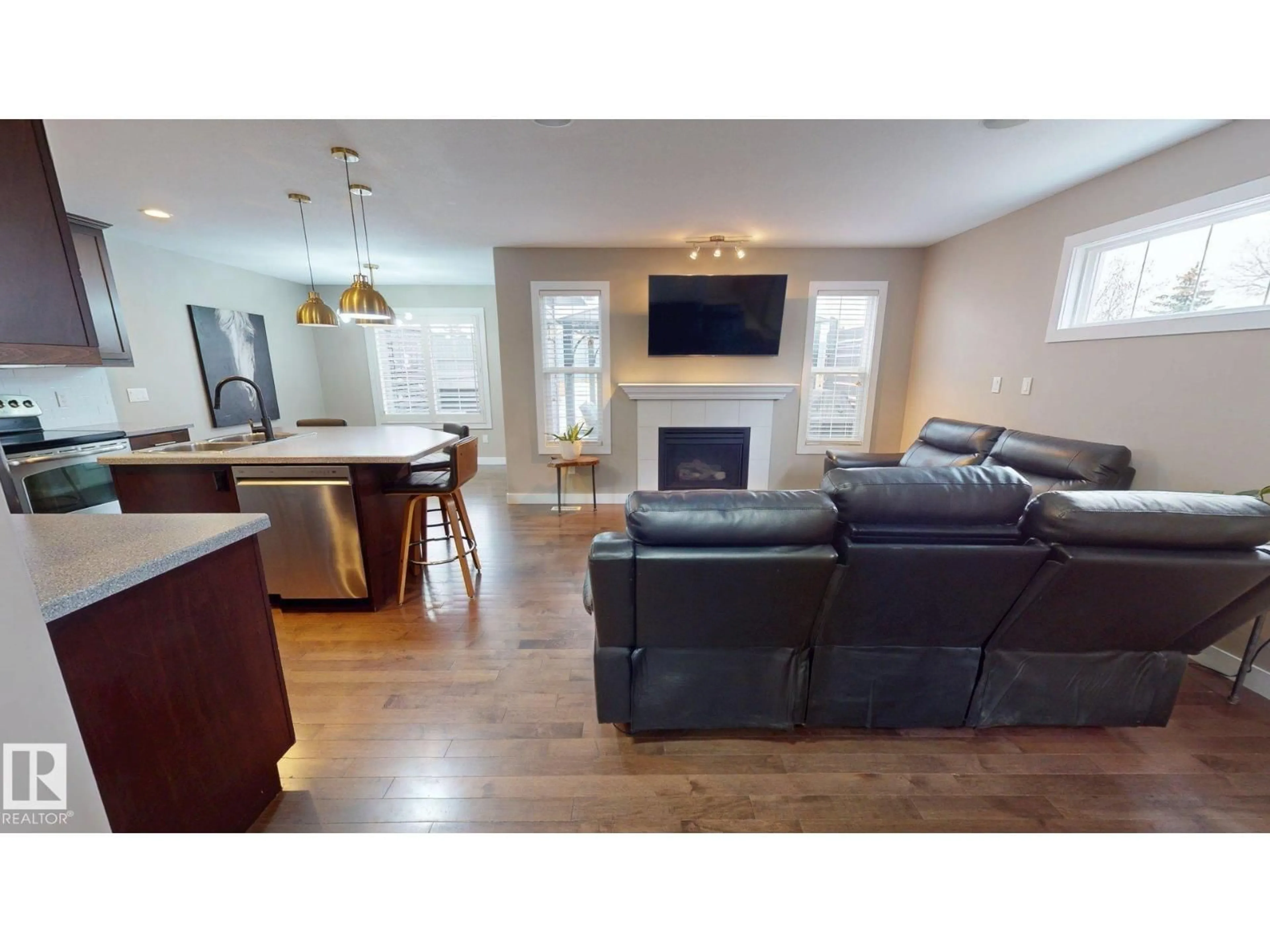 Living room with furniture, wood/laminate floor for NW - 3885 GALLINGER LO, Edmonton Alberta T5T4G6