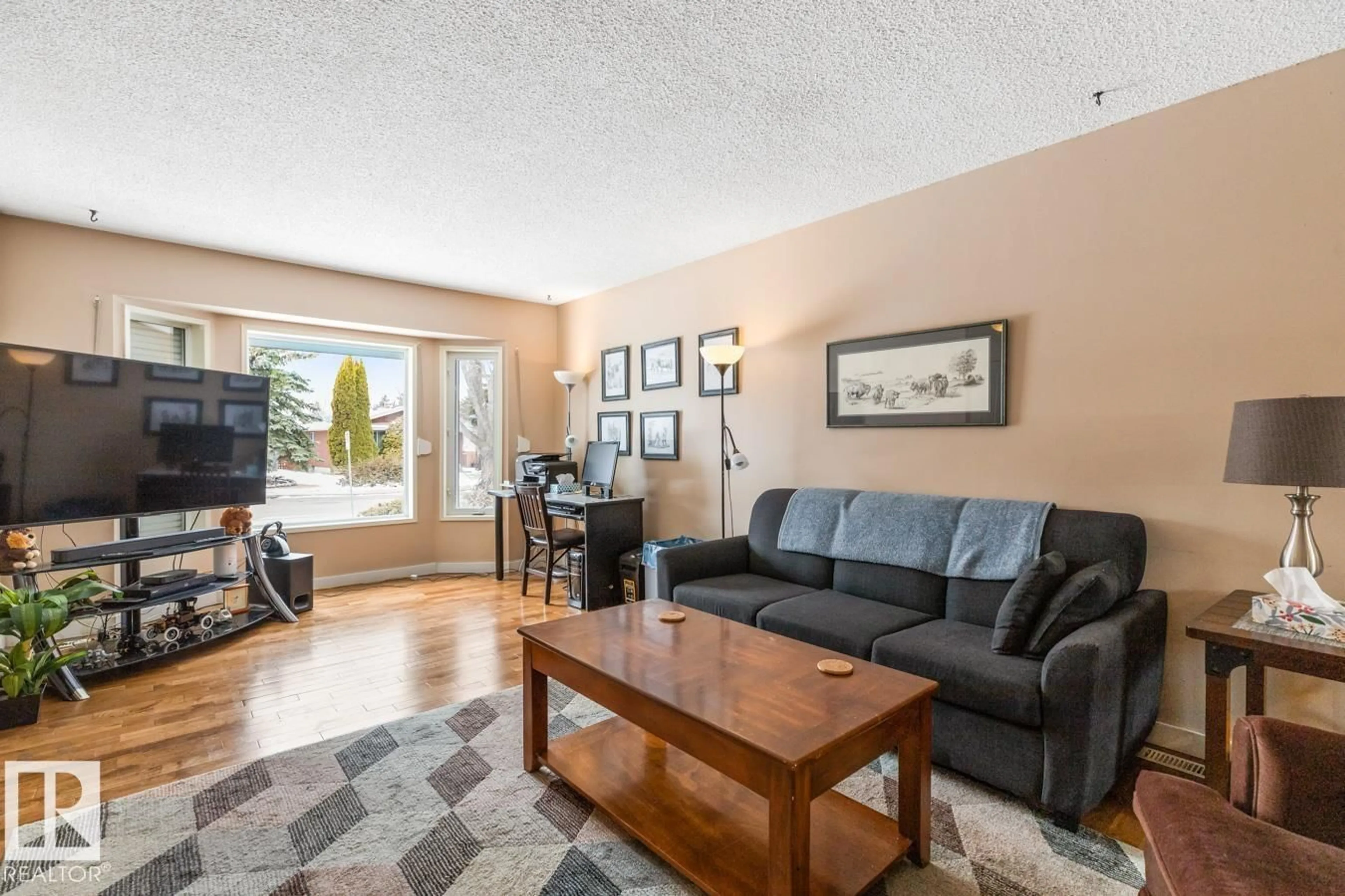 Living room with furniture, wood/laminate floor for 3959 55 ST, Edmonton Alberta T6L1C1