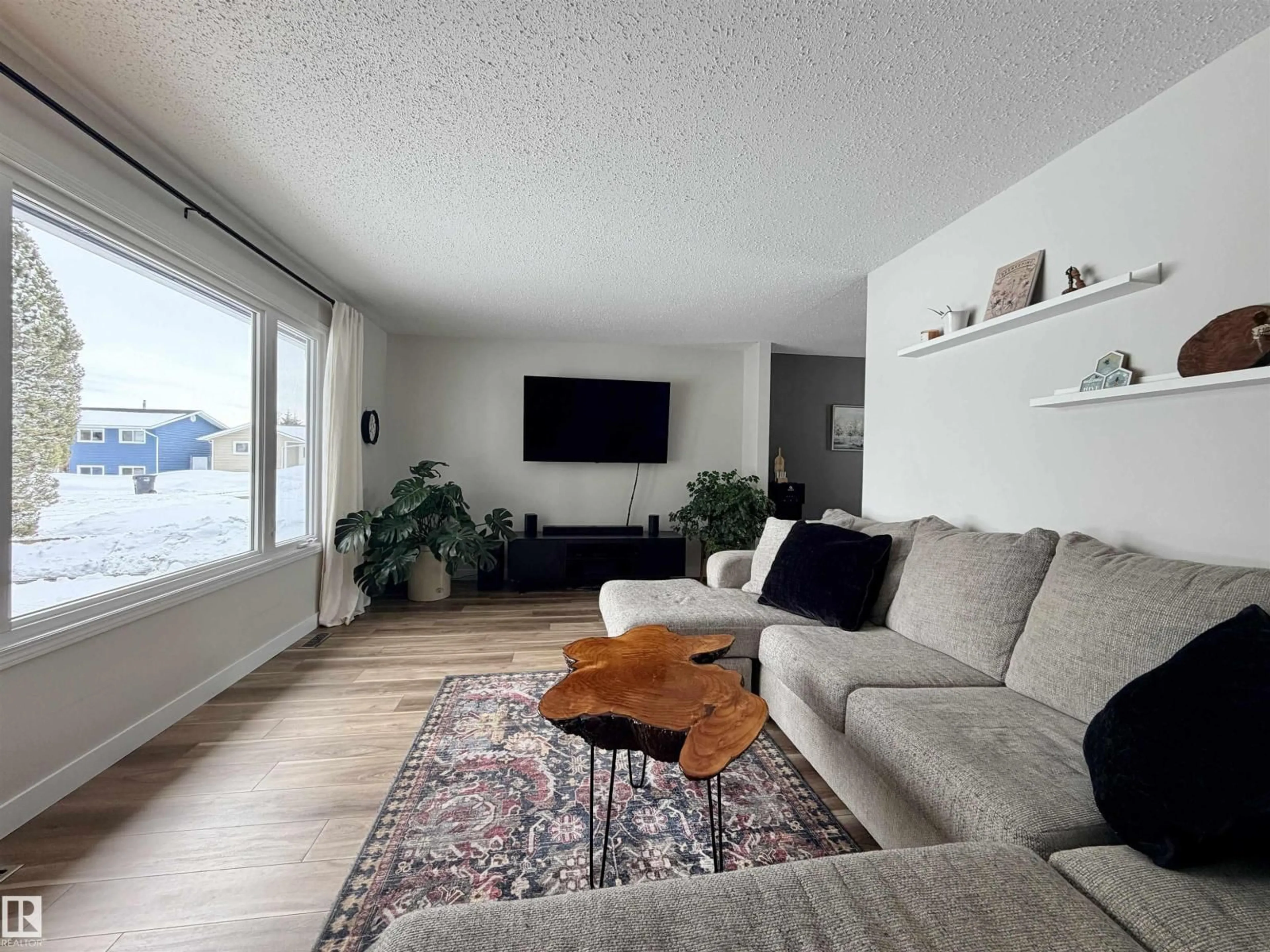 Living room with furniture, wood/laminate floor for 5206 56A ST, St. Paul Town Alberta T0A3A1