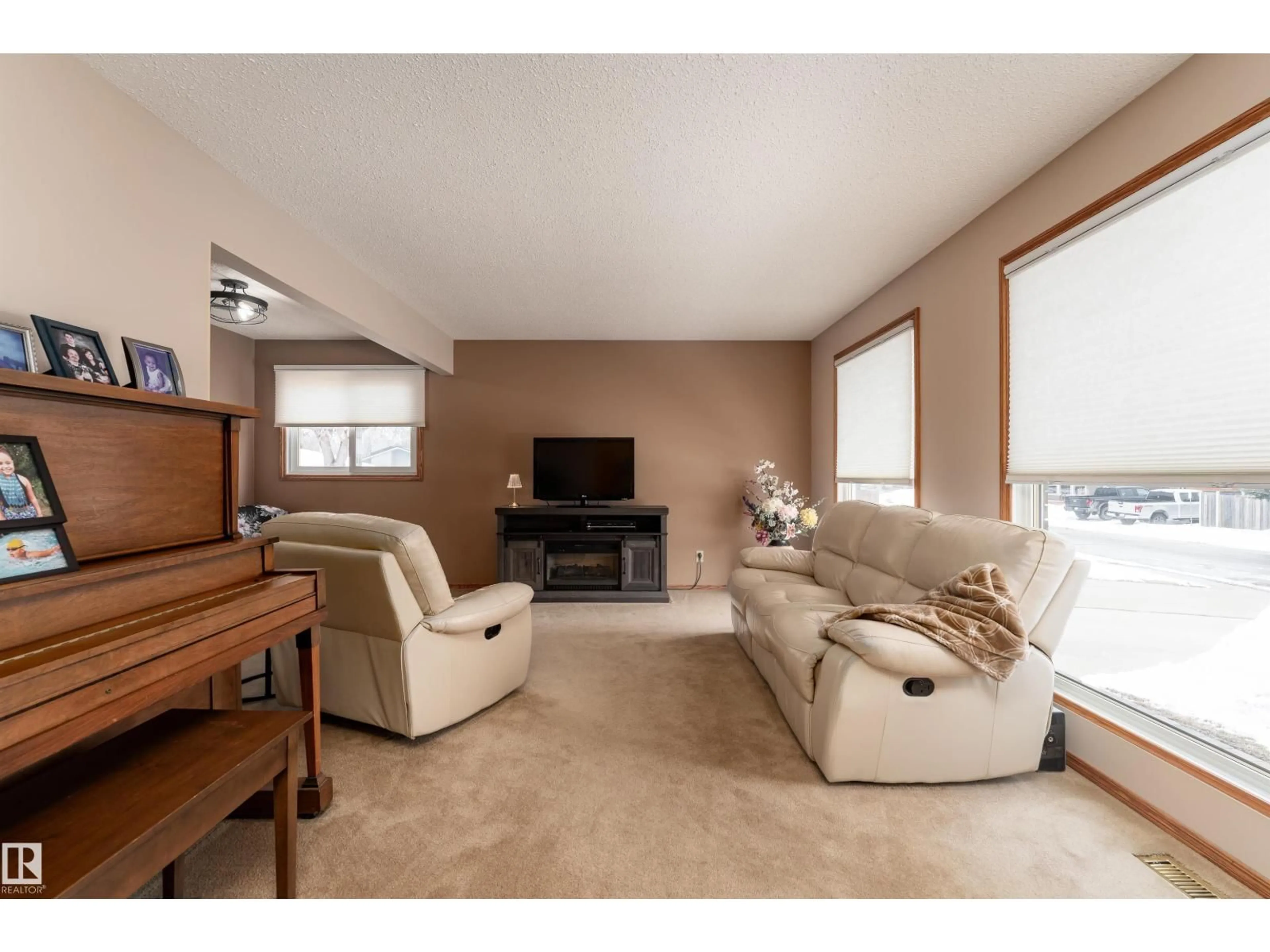 Living room with furniture, wood/laminate floor for 8326 98 AV, Fort Saskatchewan Alberta T8L3G3