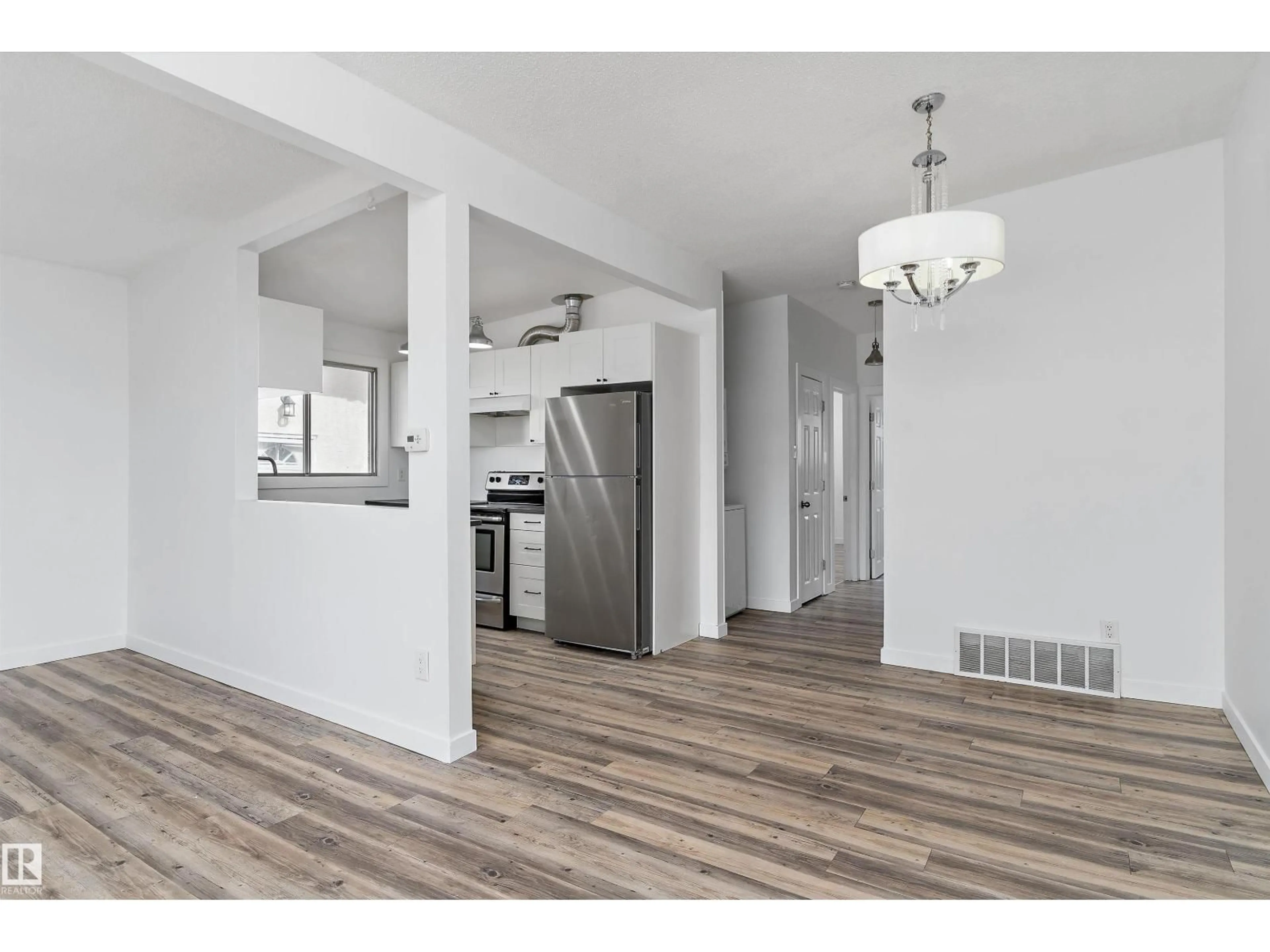 Open concept kitchen, wood/laminate floor for 6103-6105 97A AV, Edmonton Alberta T6B1E2