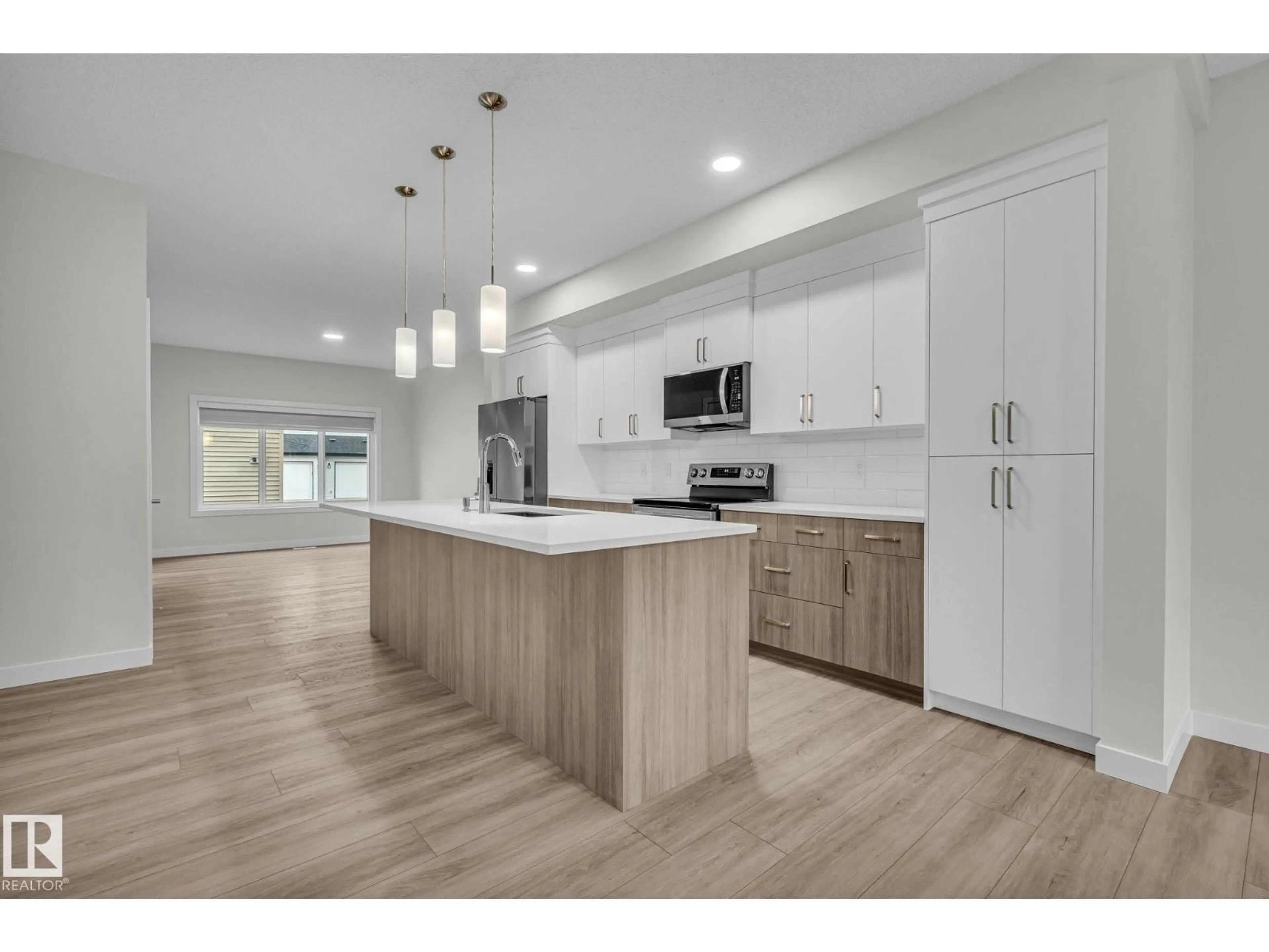 Open concept kitchen, wood/laminate floor for 307 BRAE WY, Leduc Alberta T9E1T7