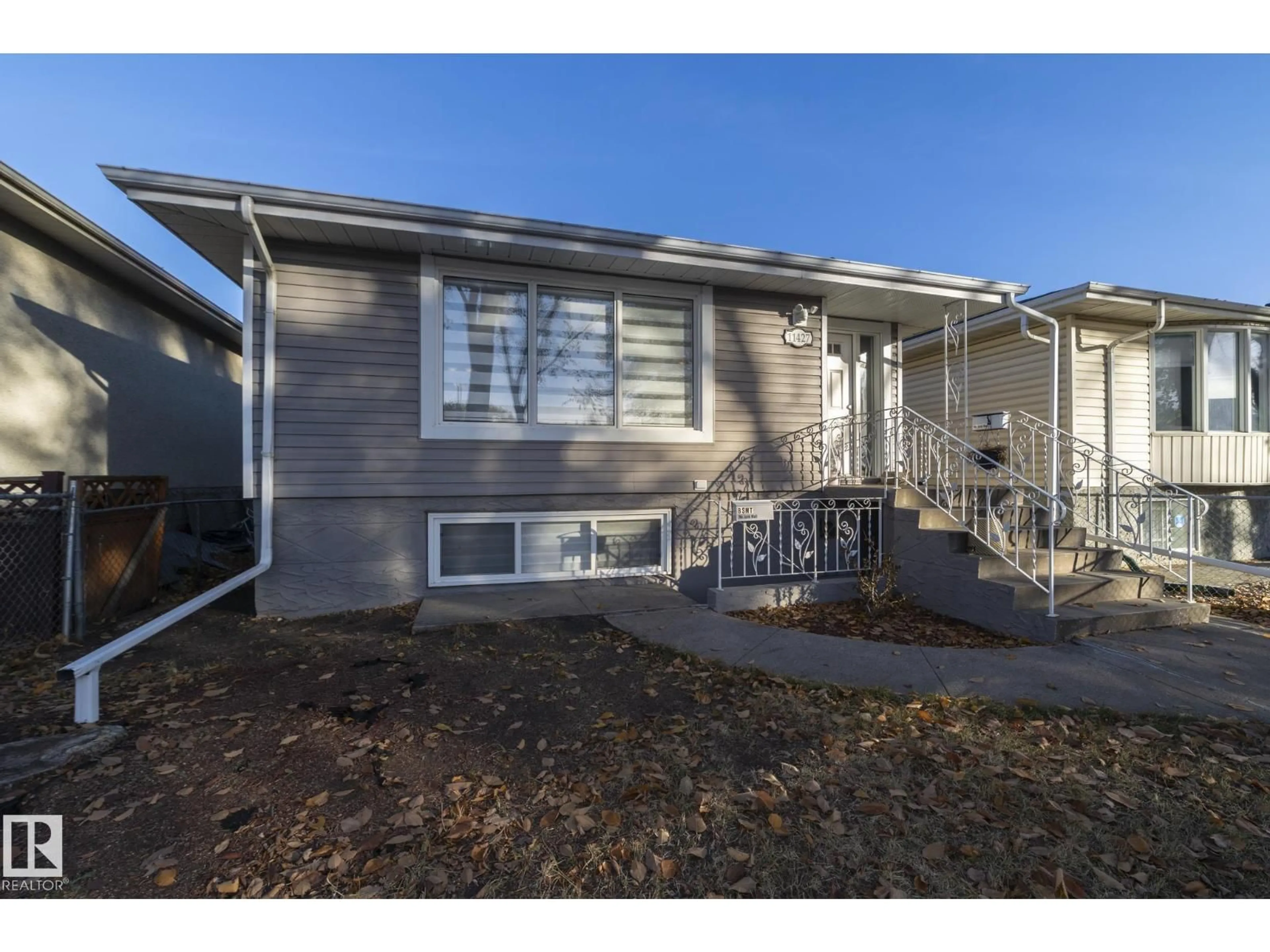Home with vinyl exterior material, street for 11427 90 ST, Edmonton Alberta T5B3X8