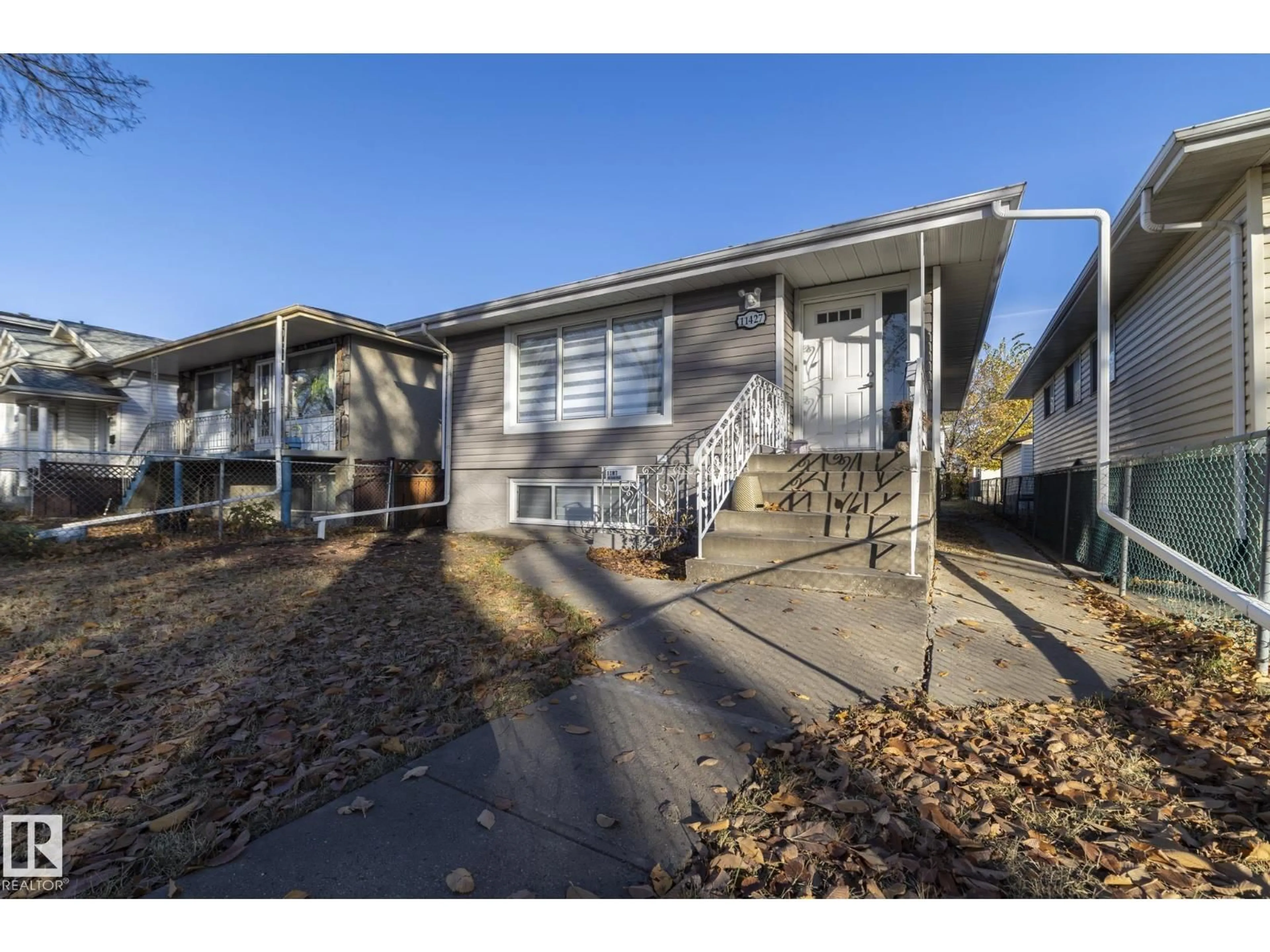 Home with vinyl exterior material, street for 11427 90 ST, Edmonton Alberta T5B3X8