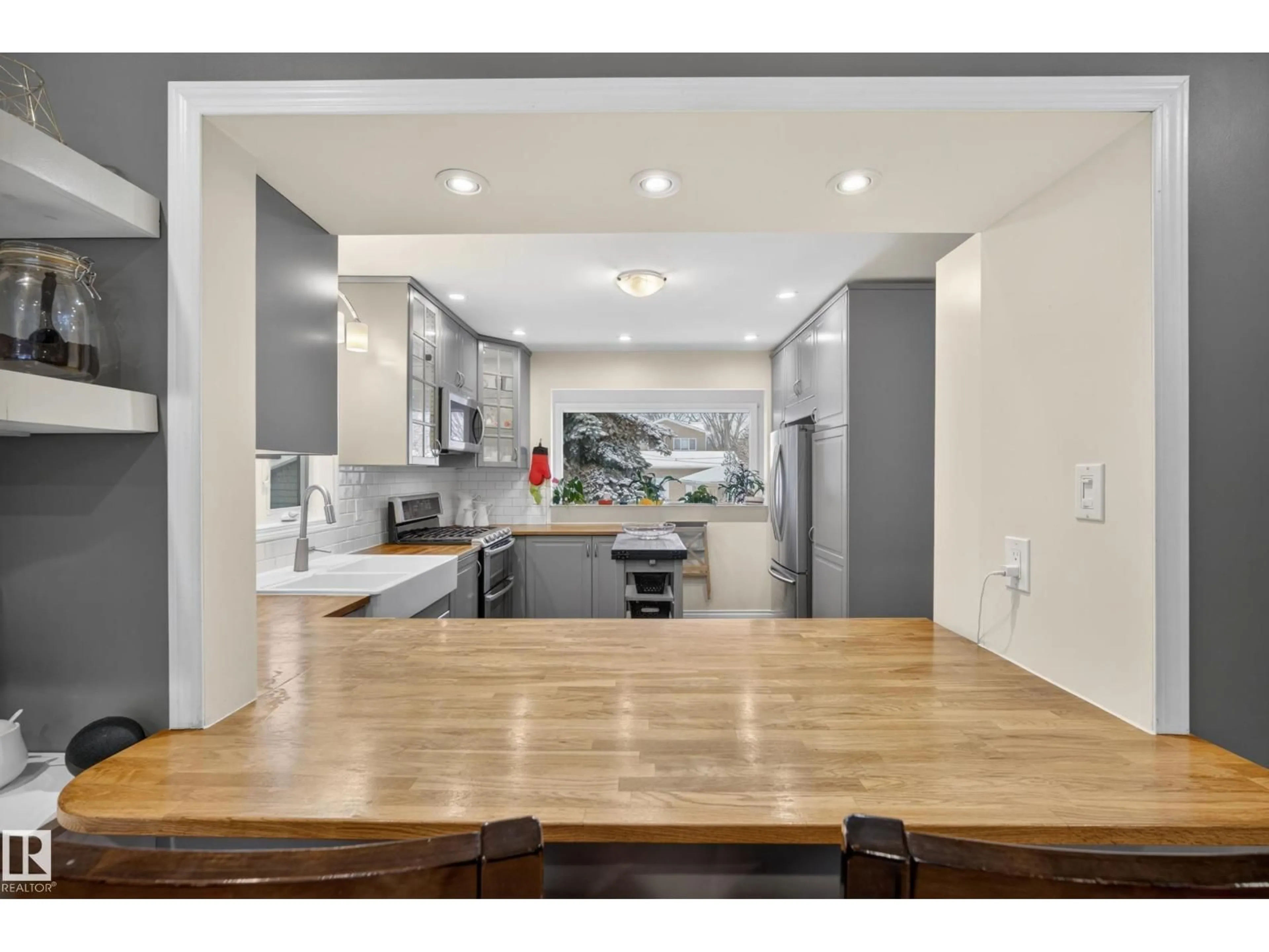 Open concept kitchen, wood/laminate floor for 10328 76 ST, Edmonton Alberta T6A3A7