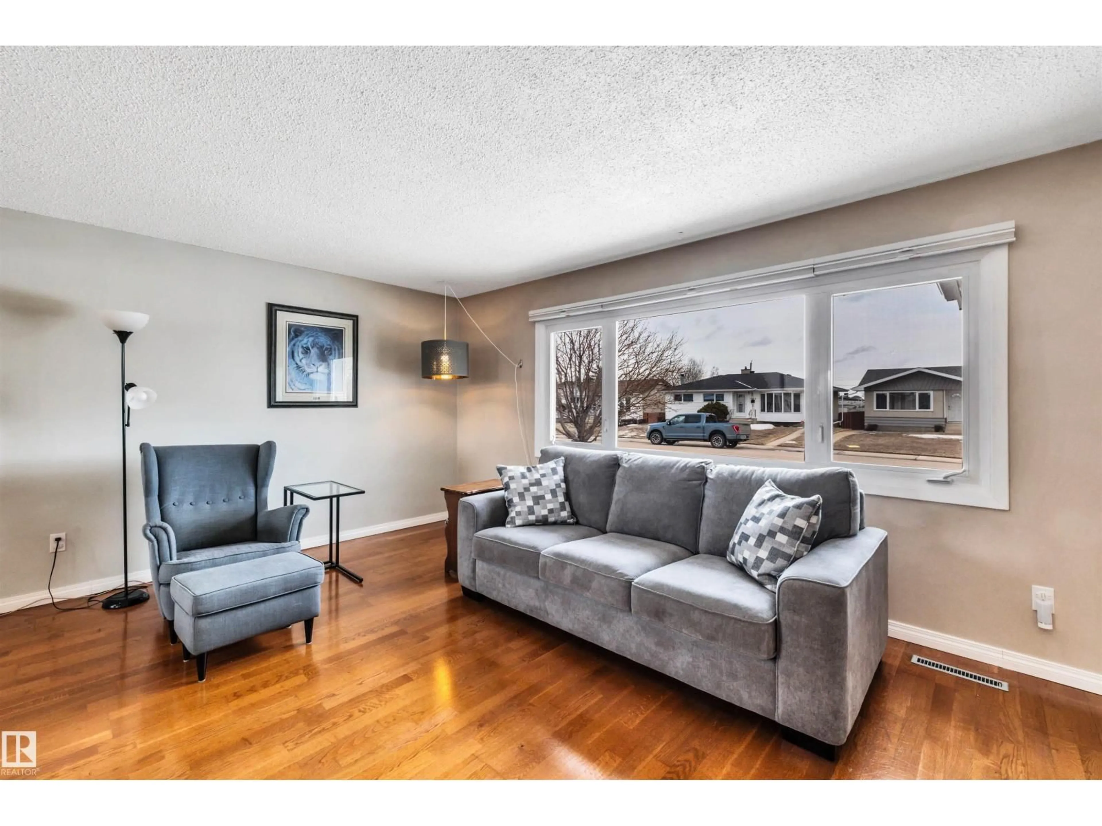 Living room with furniture, wood/laminate floor for NW - 13012 79 ST, Edmonton Alberta T5C1J3