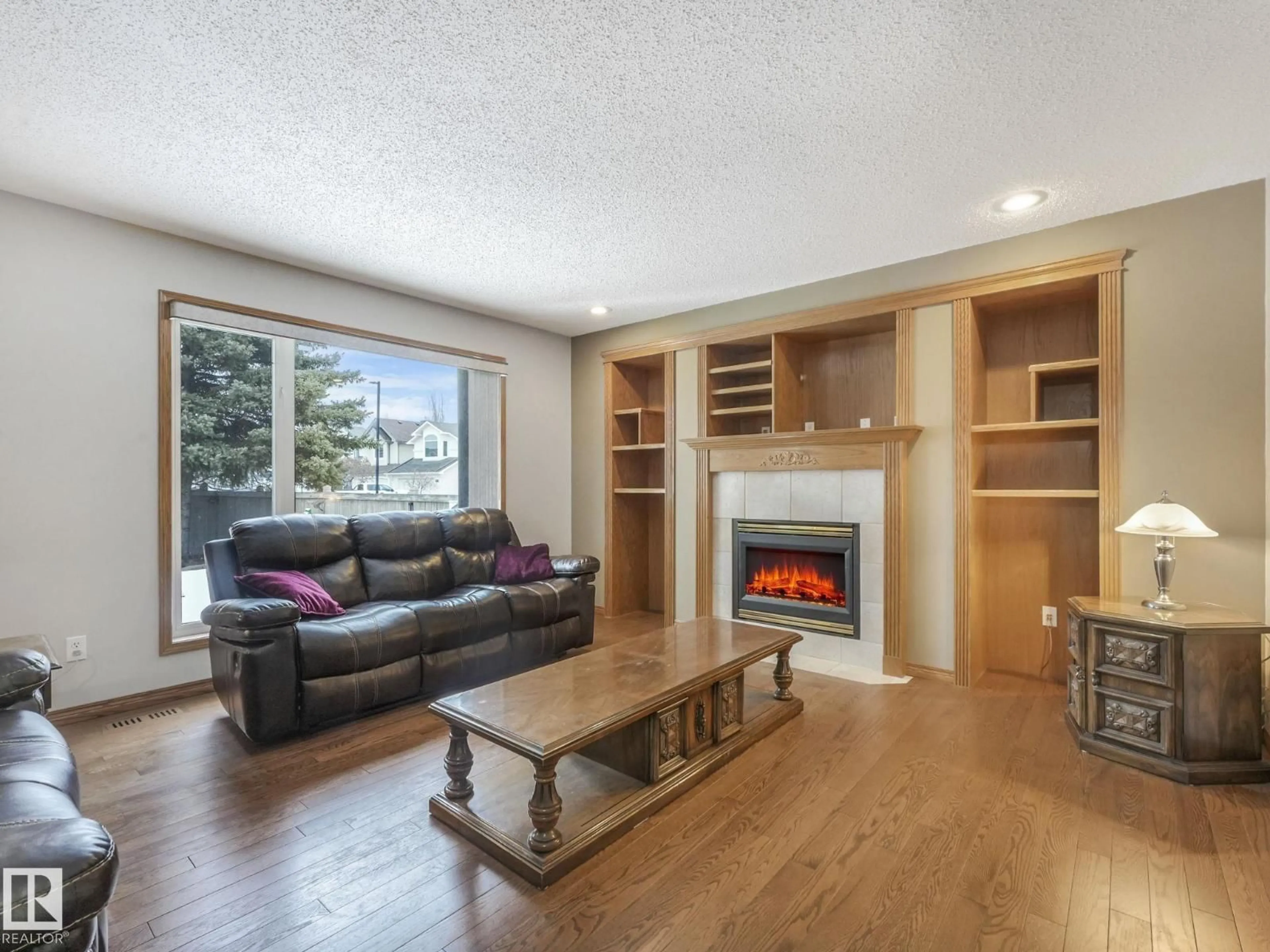 Living room with furniture, wood/laminate floor for 11704 11 AV, Edmonton Alberta T6J7C3