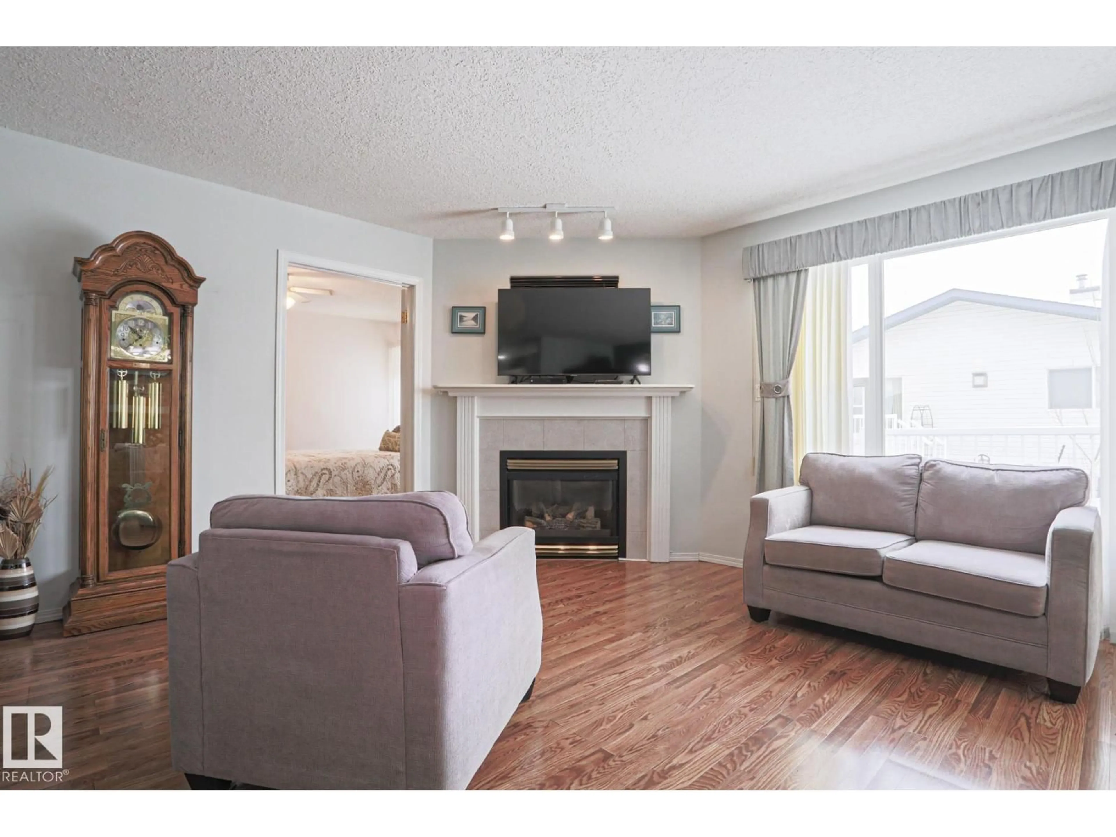 Living room with furniture, wood/laminate floor for VG - 116 MAISONETTE, Leduc Alberta T9E6T1
