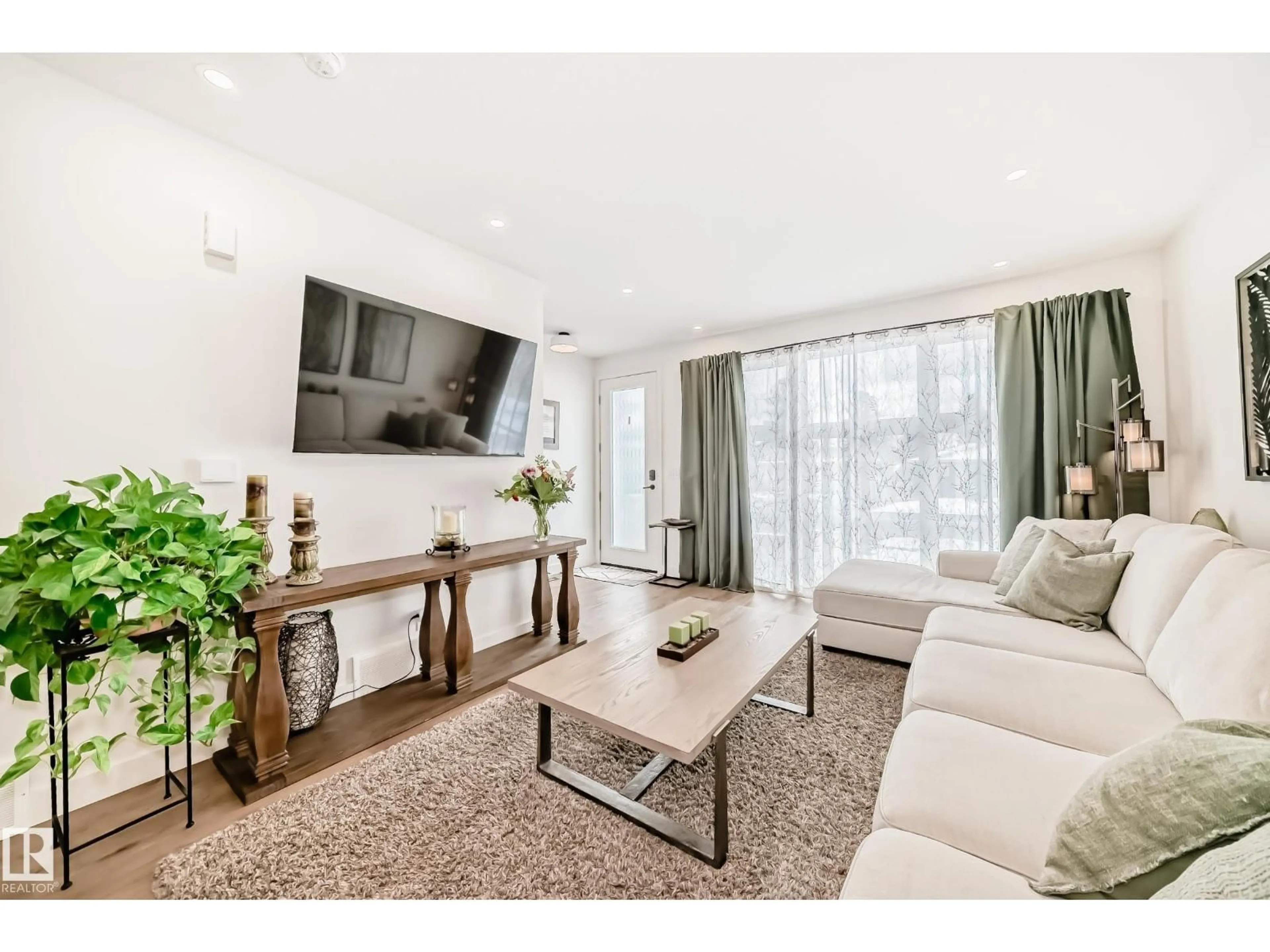 Living room with furniture, wood/laminate floor for NW - 10936 117 ST, Edmonton Alberta T5H3N6