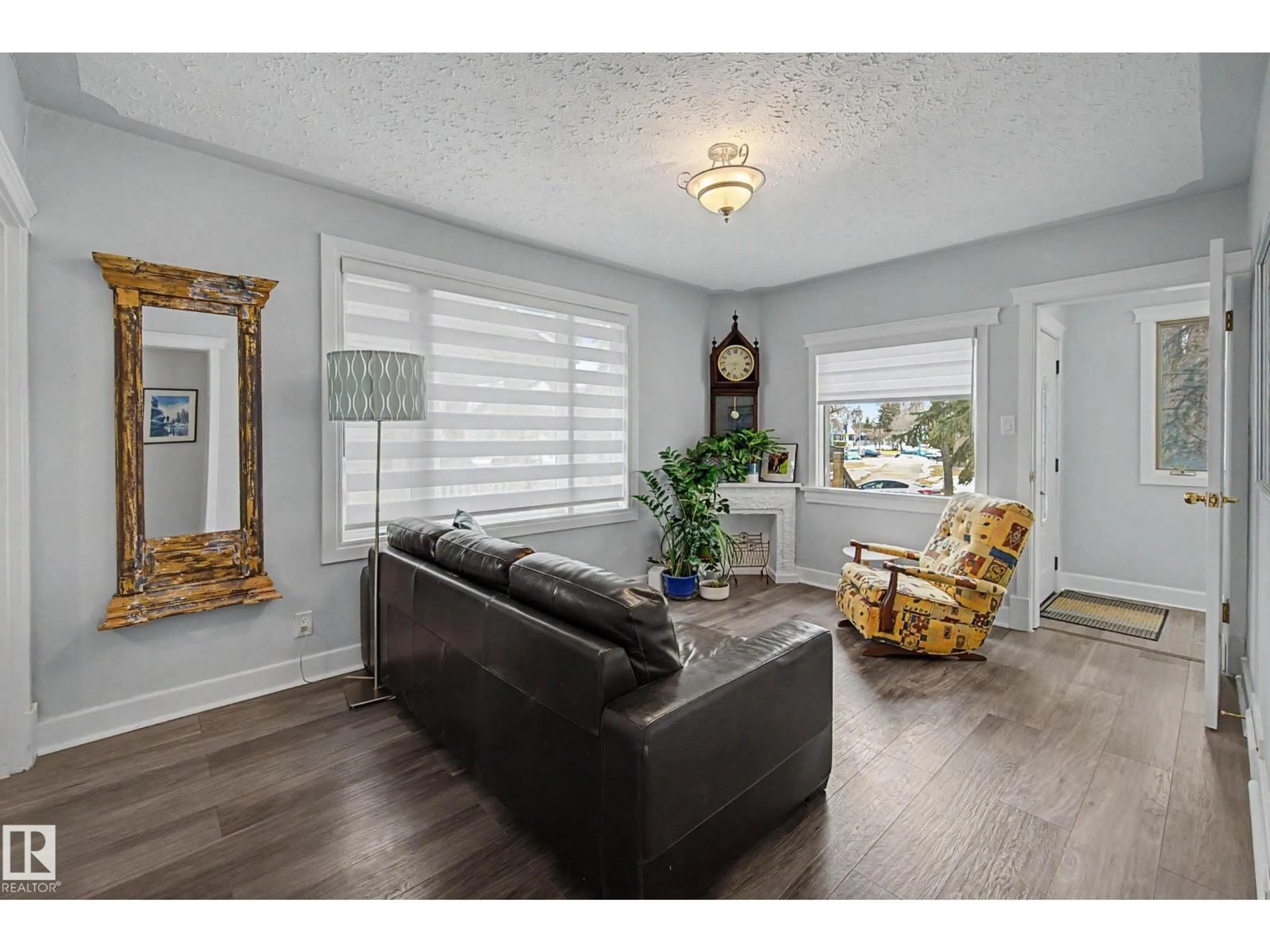 Living room with furniture, wood/laminate floor for NW - 11415 68 ST, Edmonton Alberta T5B1N9