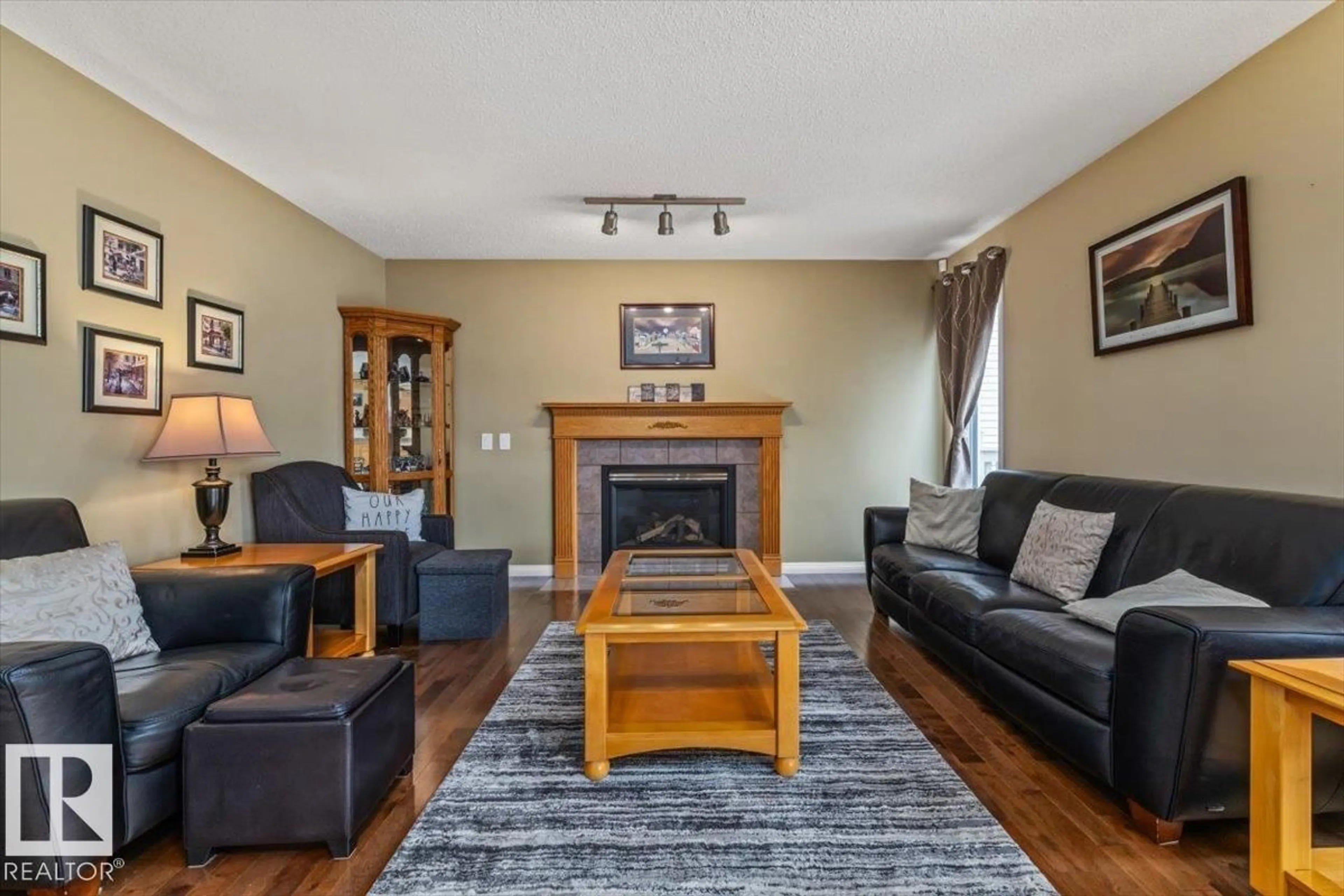 Living room with furniture, wood/laminate floor for 520 WISEMAN LN, Edmonton Alberta T6T1N6