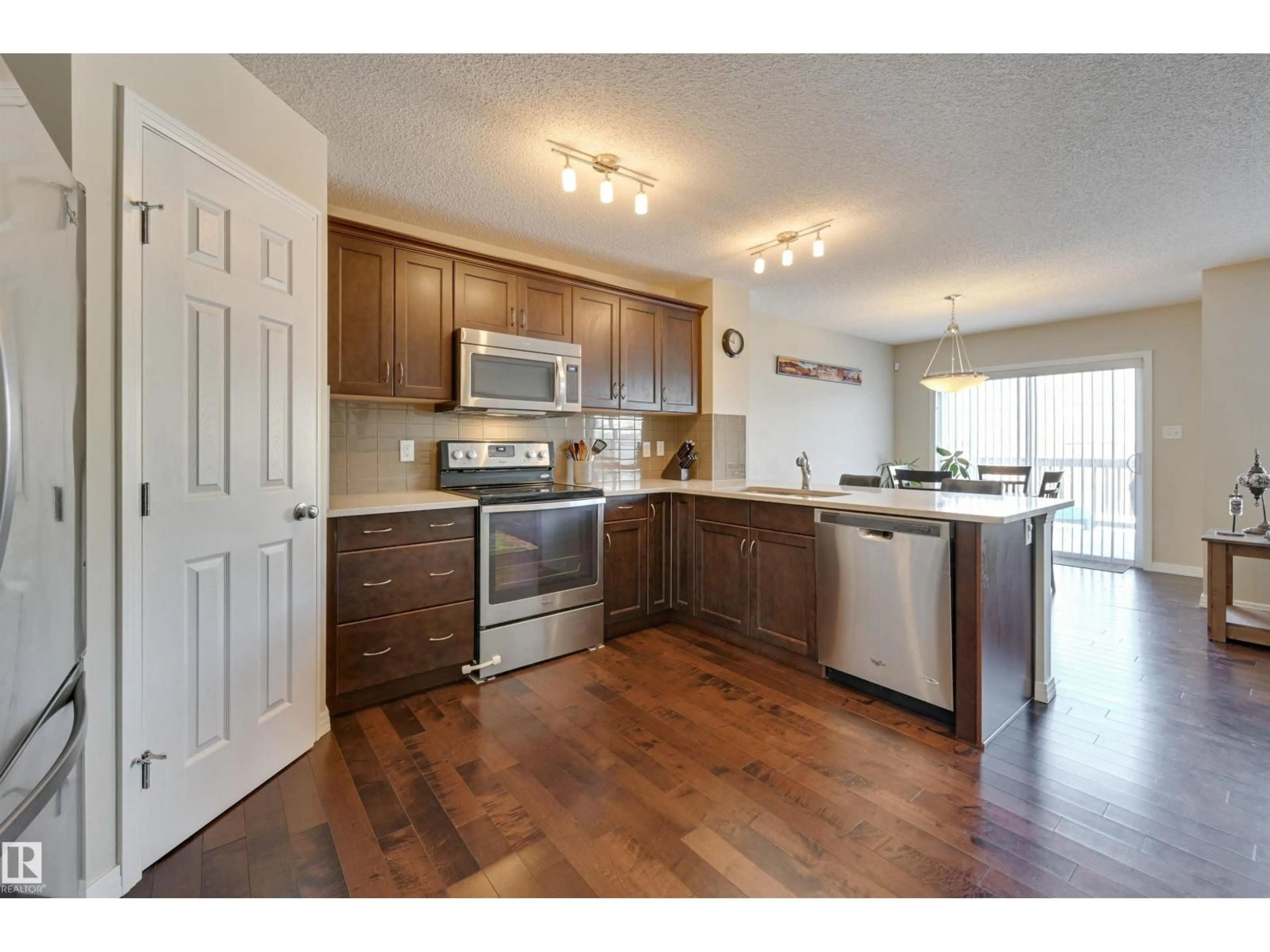 Open concept kitchen, wood/laminate floor for 1426 152 AV, Edmonton Alberta T5Y0Y7